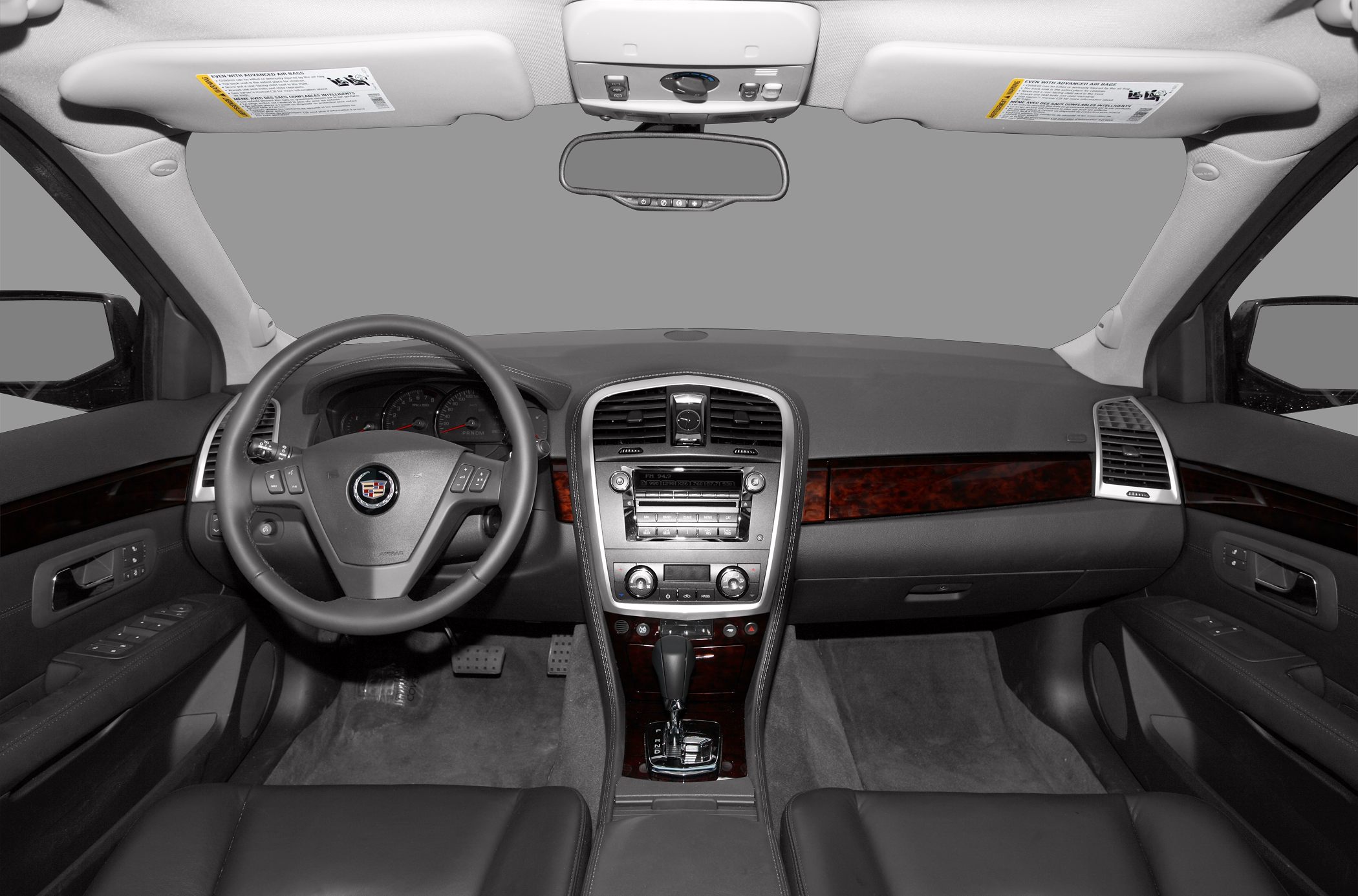 Dashboard and steering wheel with wood trim and control panel