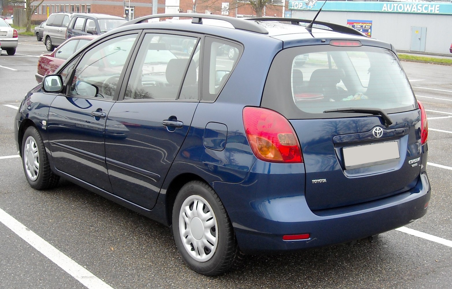 Compact MPV rear three-quarter view with roof rails and distinctive rear lights