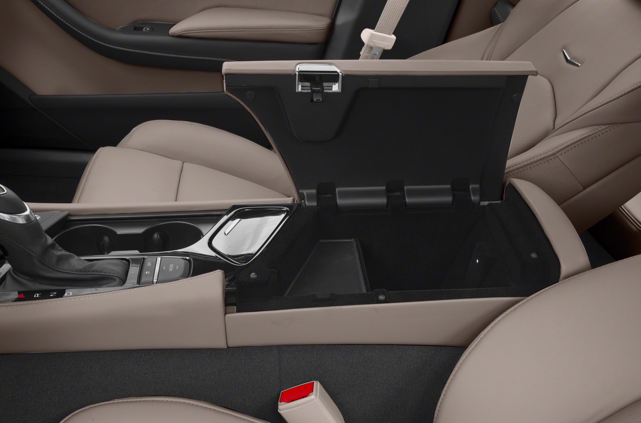 Center console storage with gear shift and beige leather seats