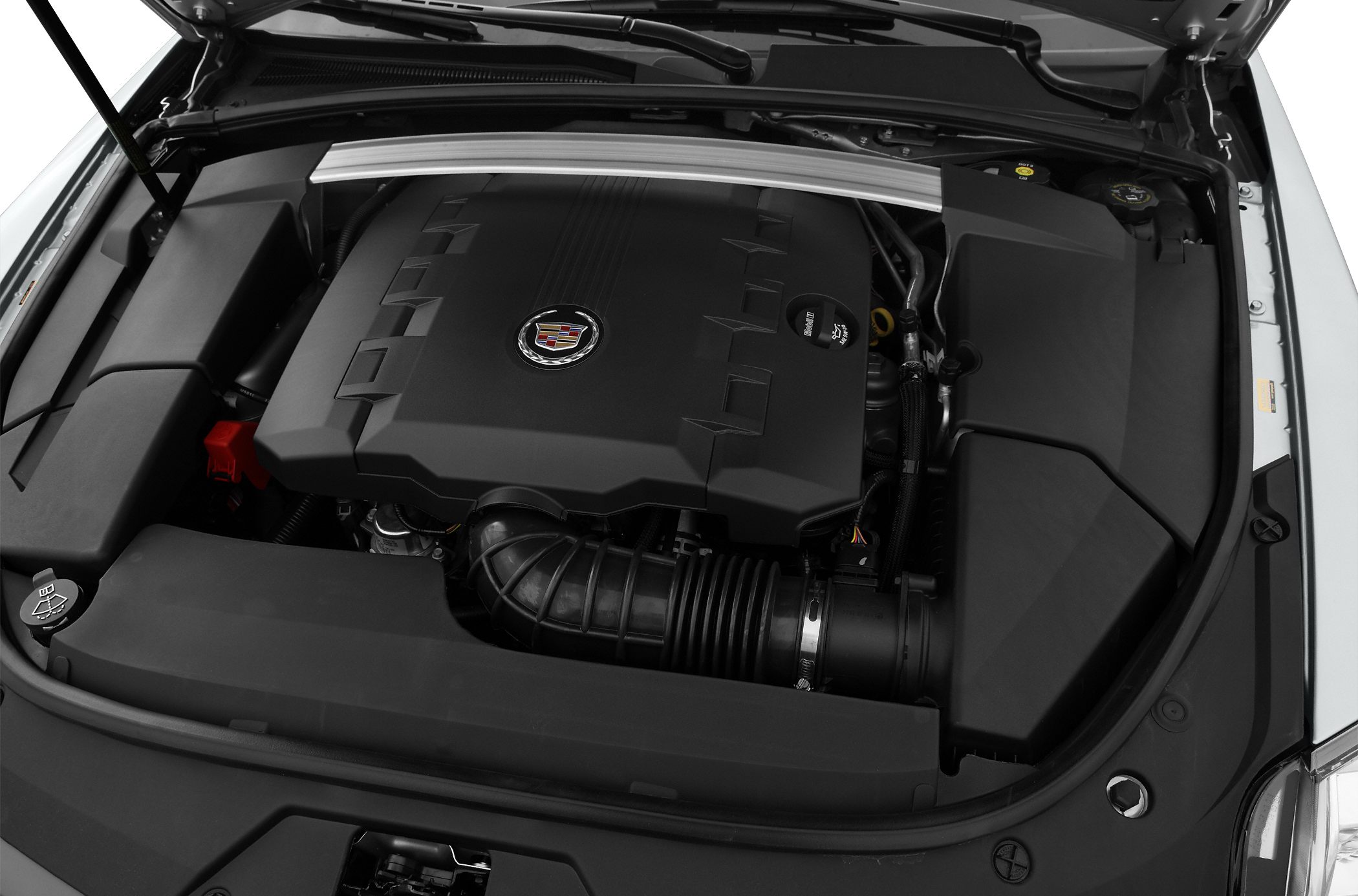 Modern car engine bay with large engine cover and structural brace