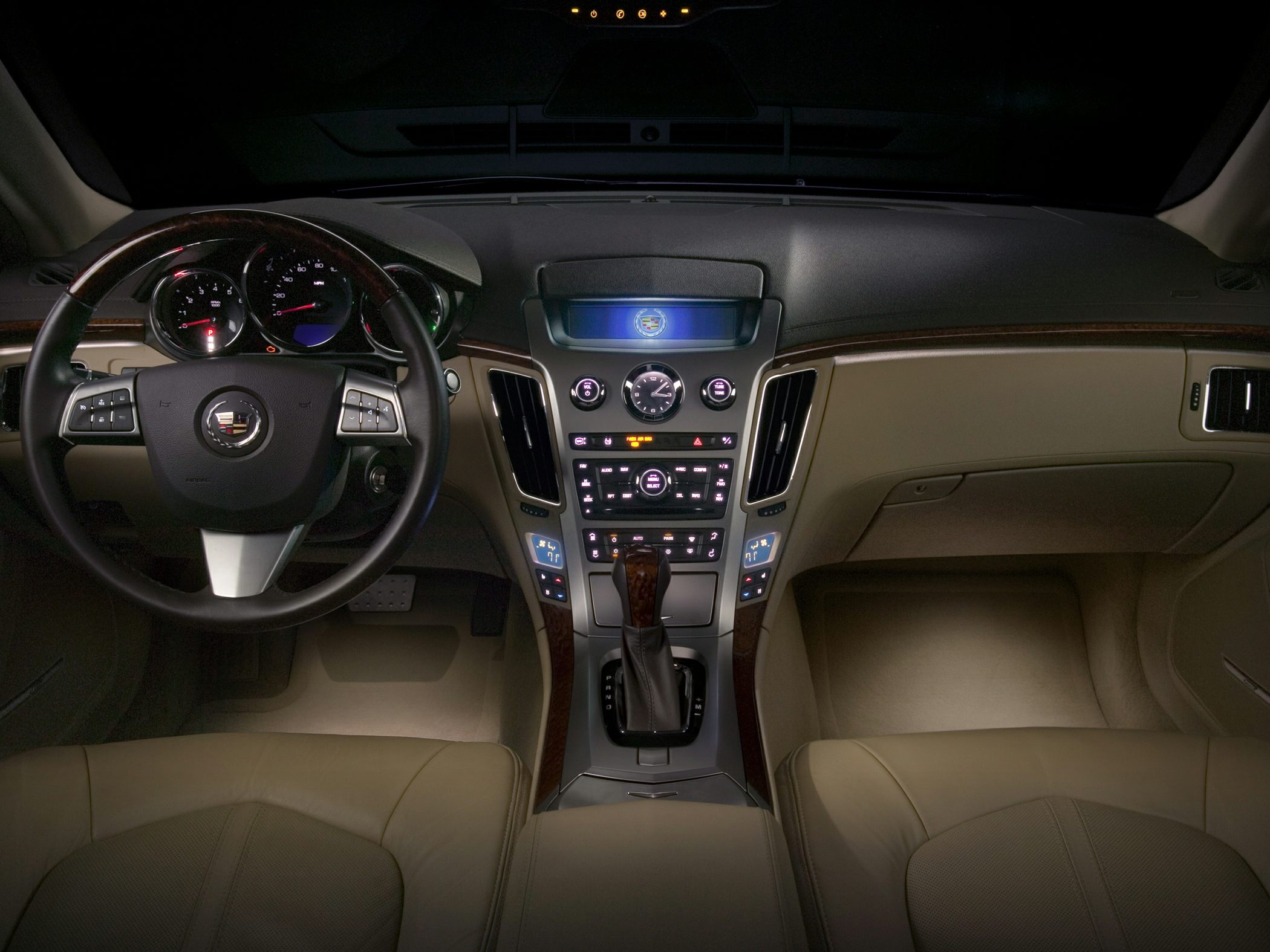 Dashboard and steering wheel with controls in luxury car interior