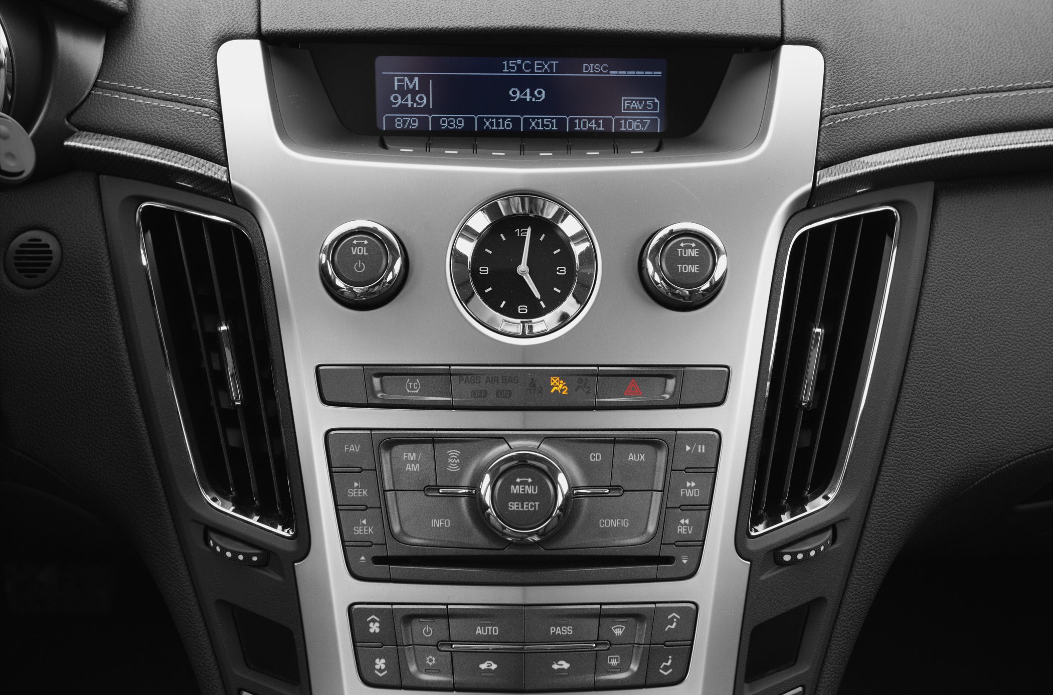 Central console with analog clock and multimedia controls