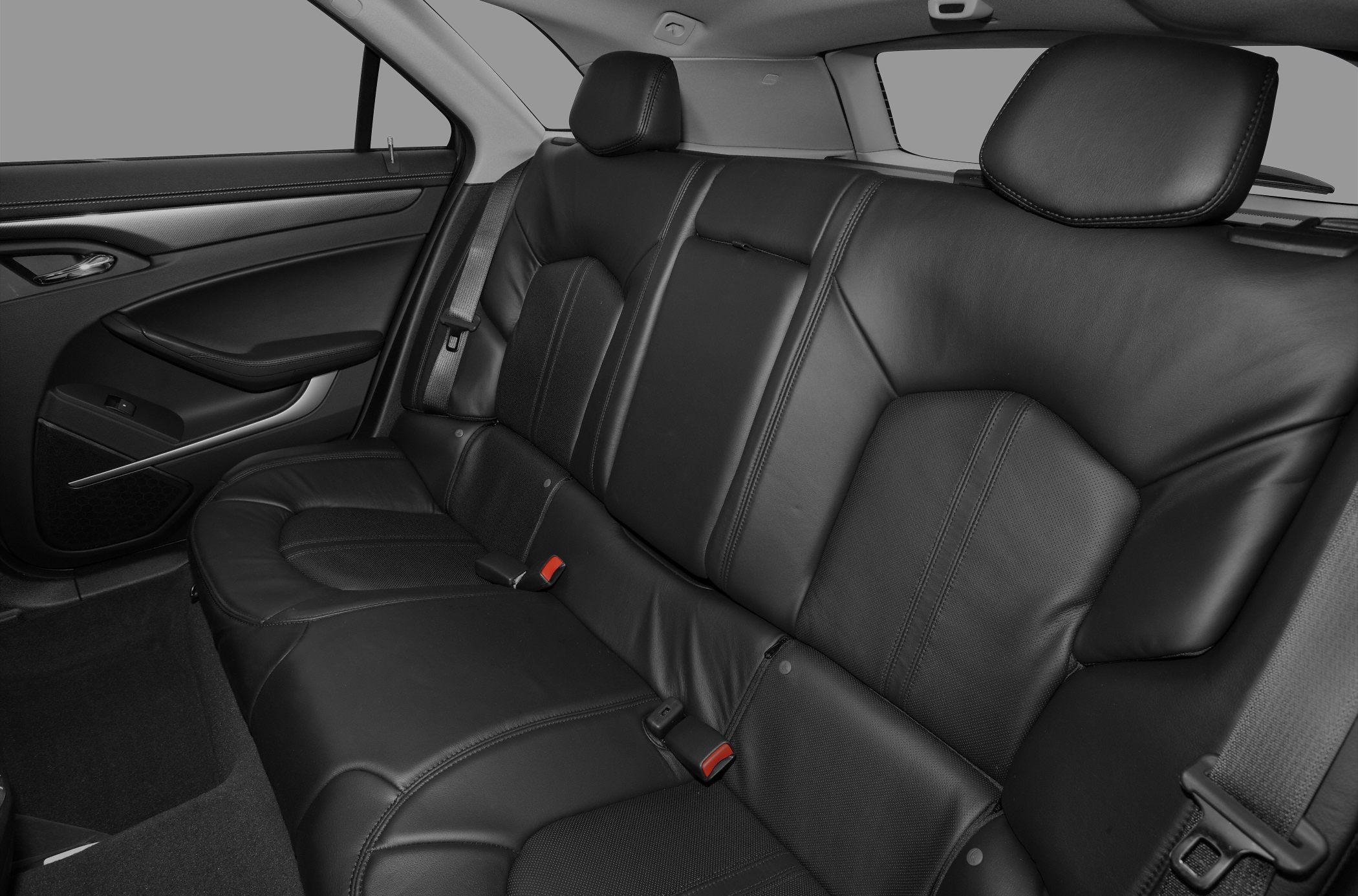 Black leather rear seats with seat belts and detailed stitching
