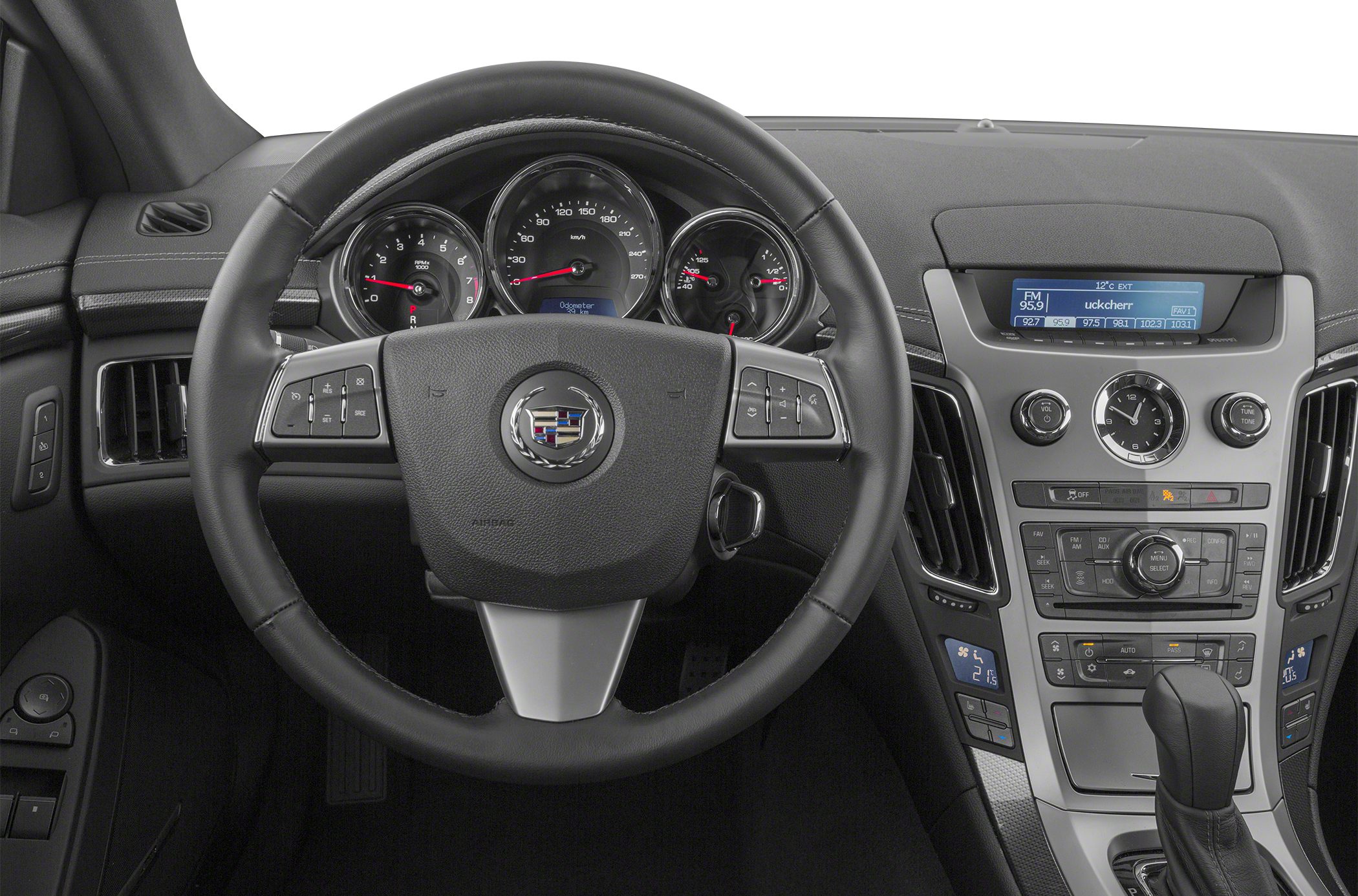 Steering wheel and dashboard with analog gauges and infotainment screen