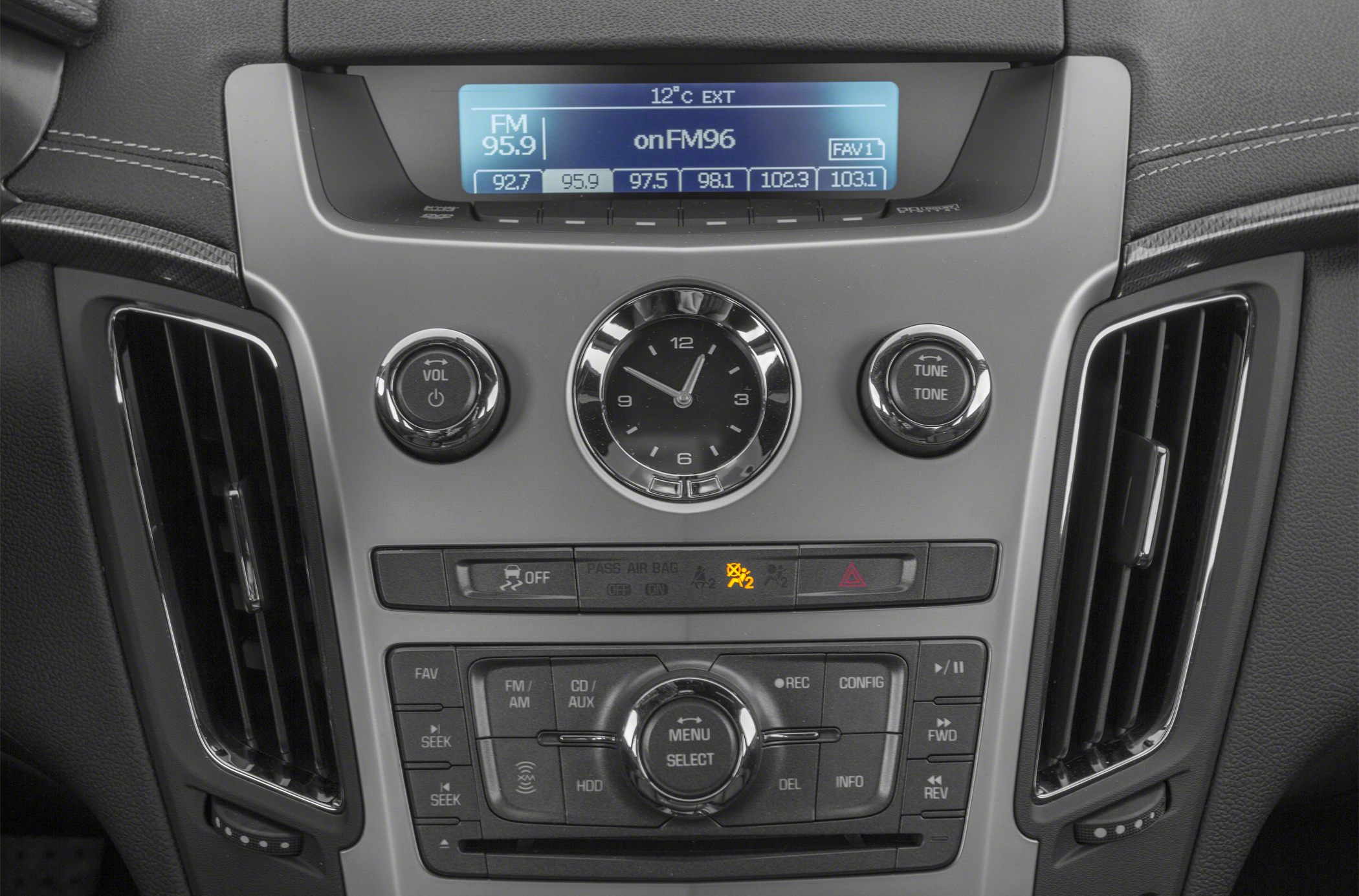 Center console with audio controls and analog clock