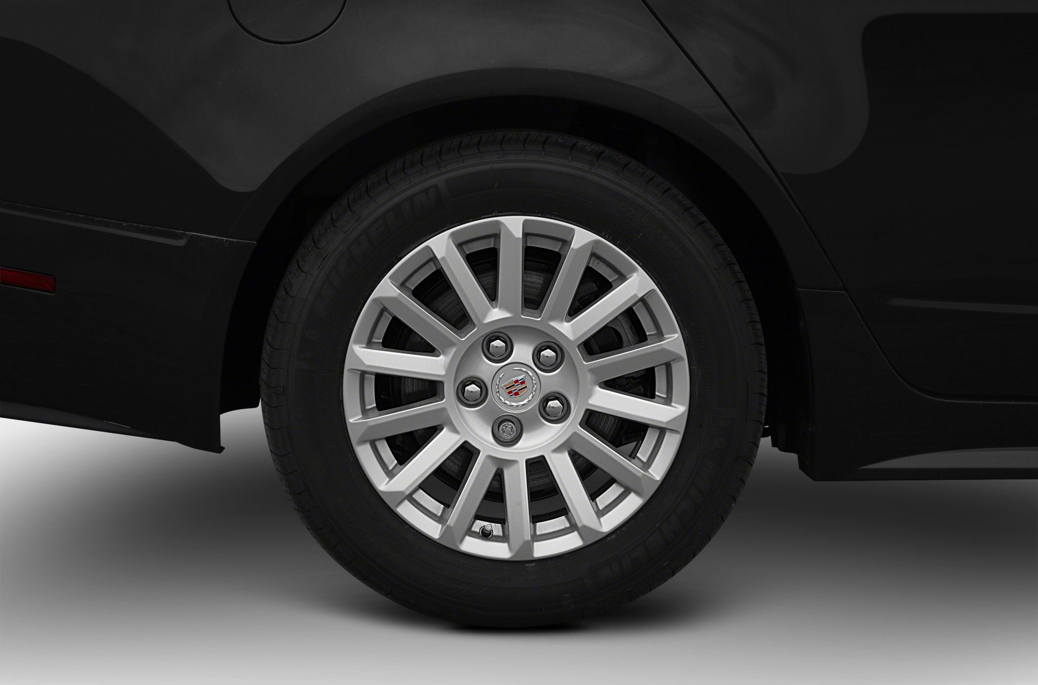 Multi-spoke alloy wheel with Michelin tire on black vehicle