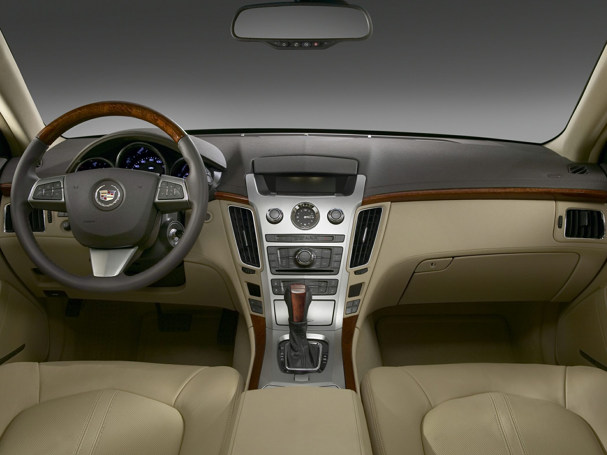 Dashboard, steering wheel, and central console with wood trim