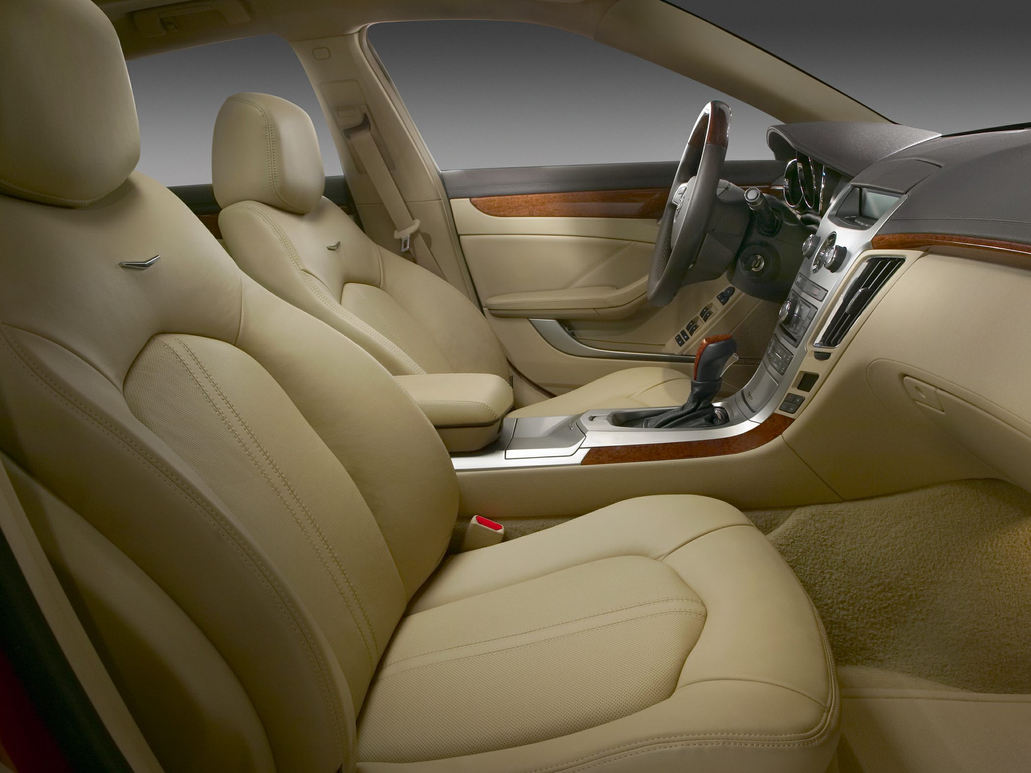 Beige leather seats and wood accent dashboard interior