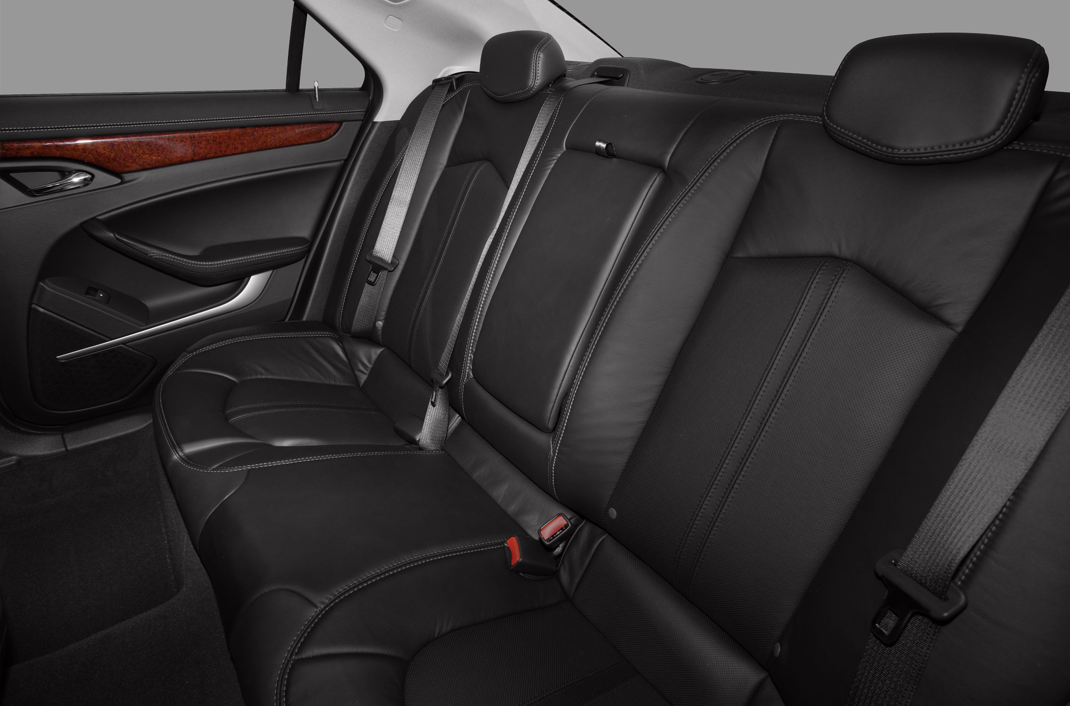 Rear leather seats and door panel with wood trim and seatbelts