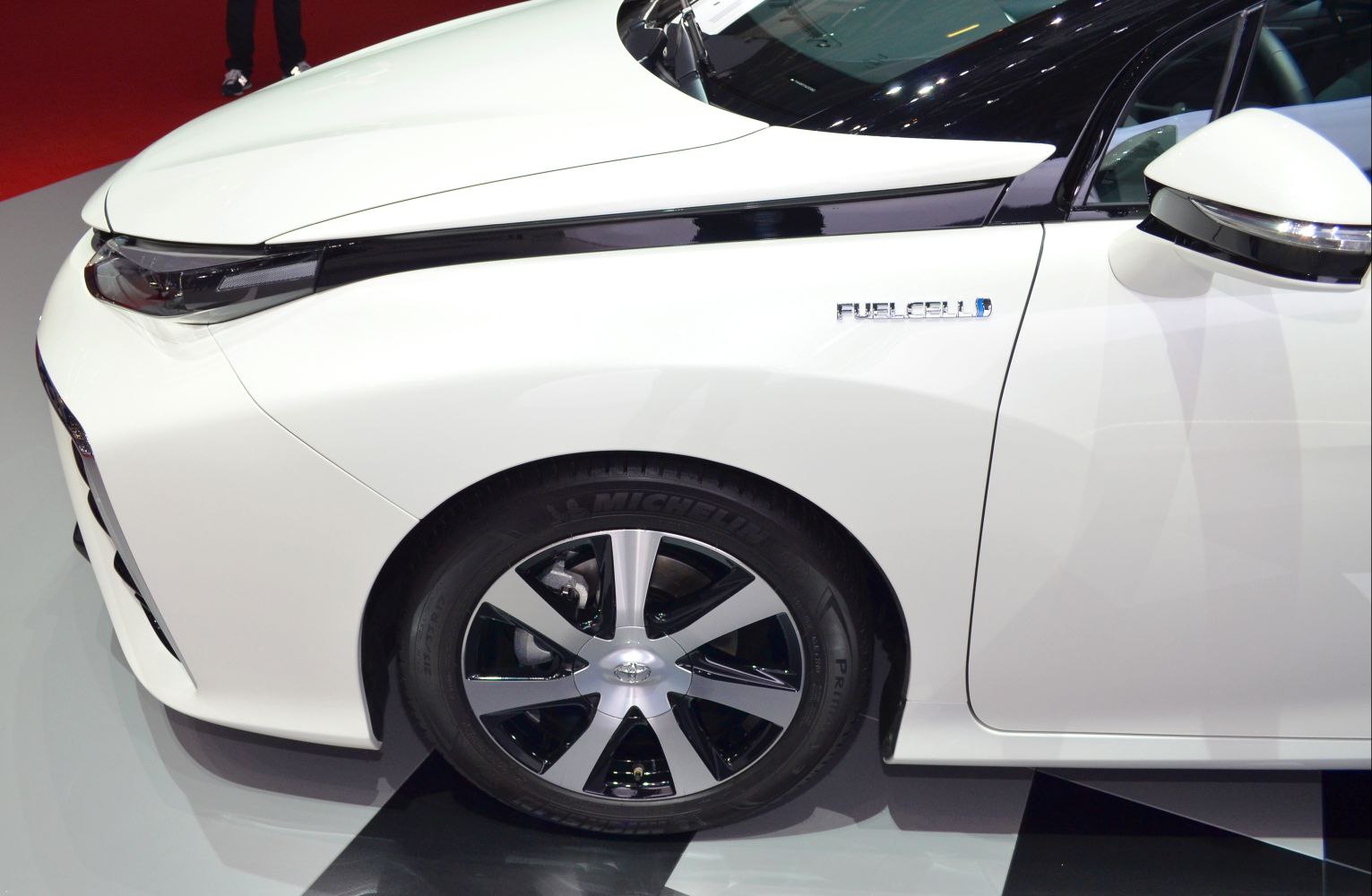 Close-up of front wheel, headlight, and fuel cell badge