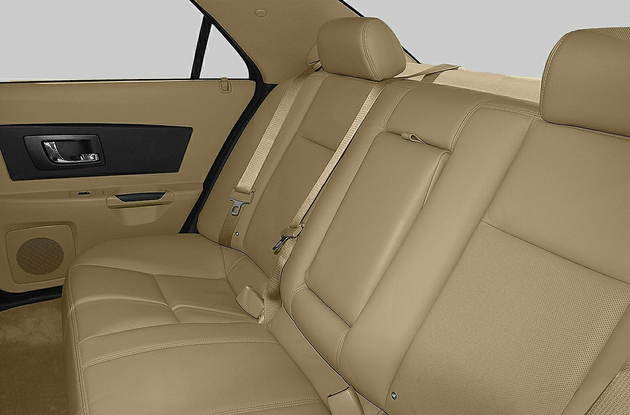 Beige leather rear seats with seat belts and door panel