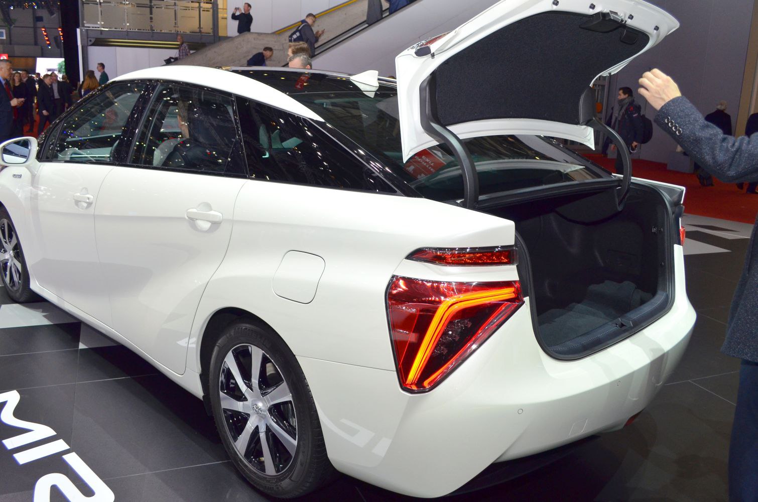 Rear view of sedan with open trunk and illuminated LED taillights