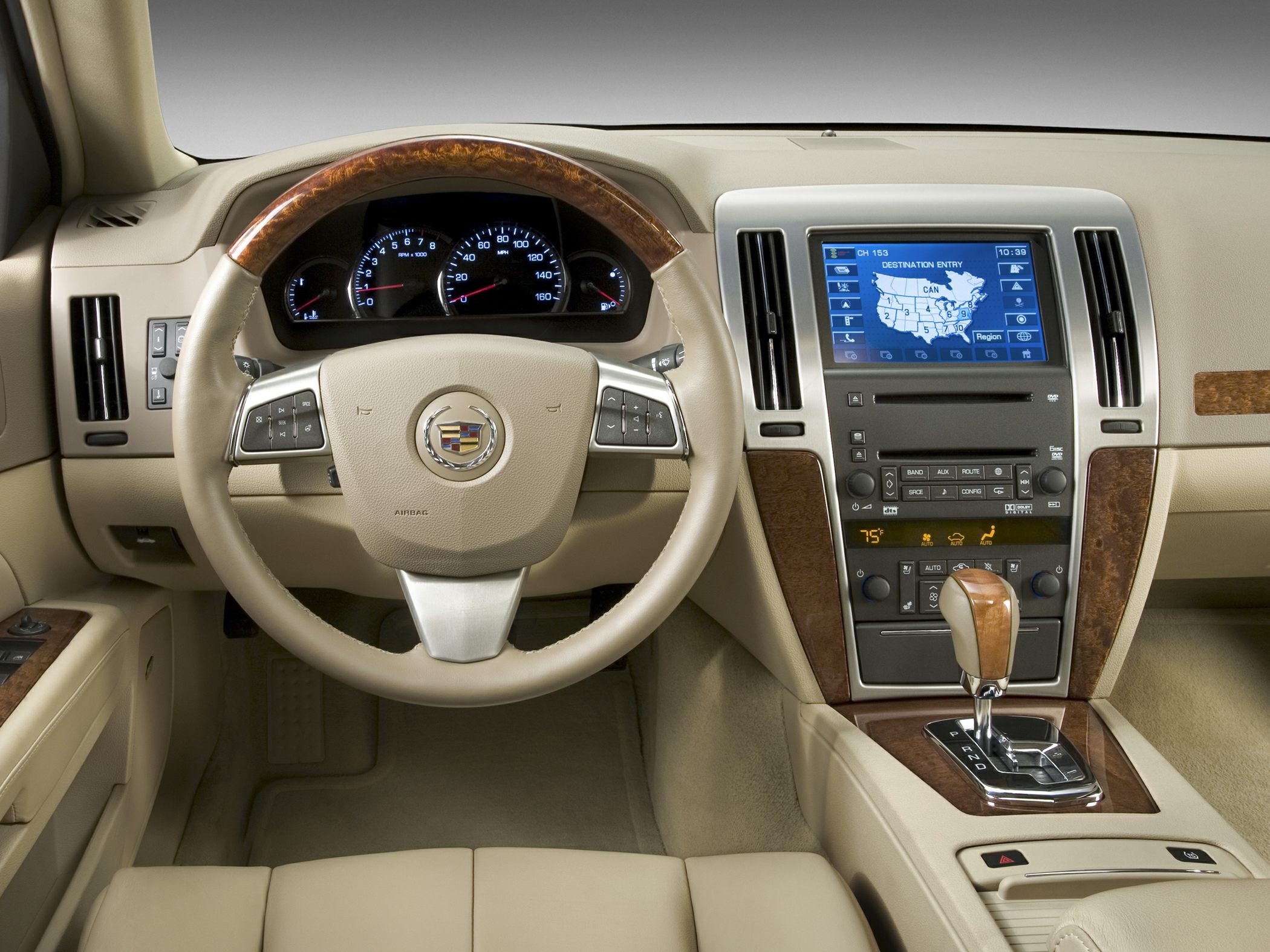 Wood-trimmed steering wheel and infotainment system with navigation display