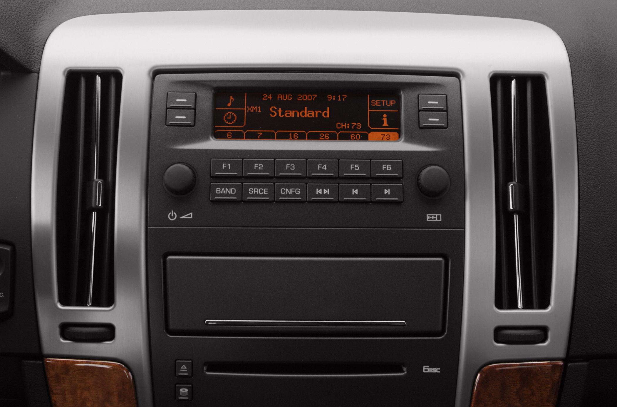 Close-up of car radio panel with digital display and climate vents