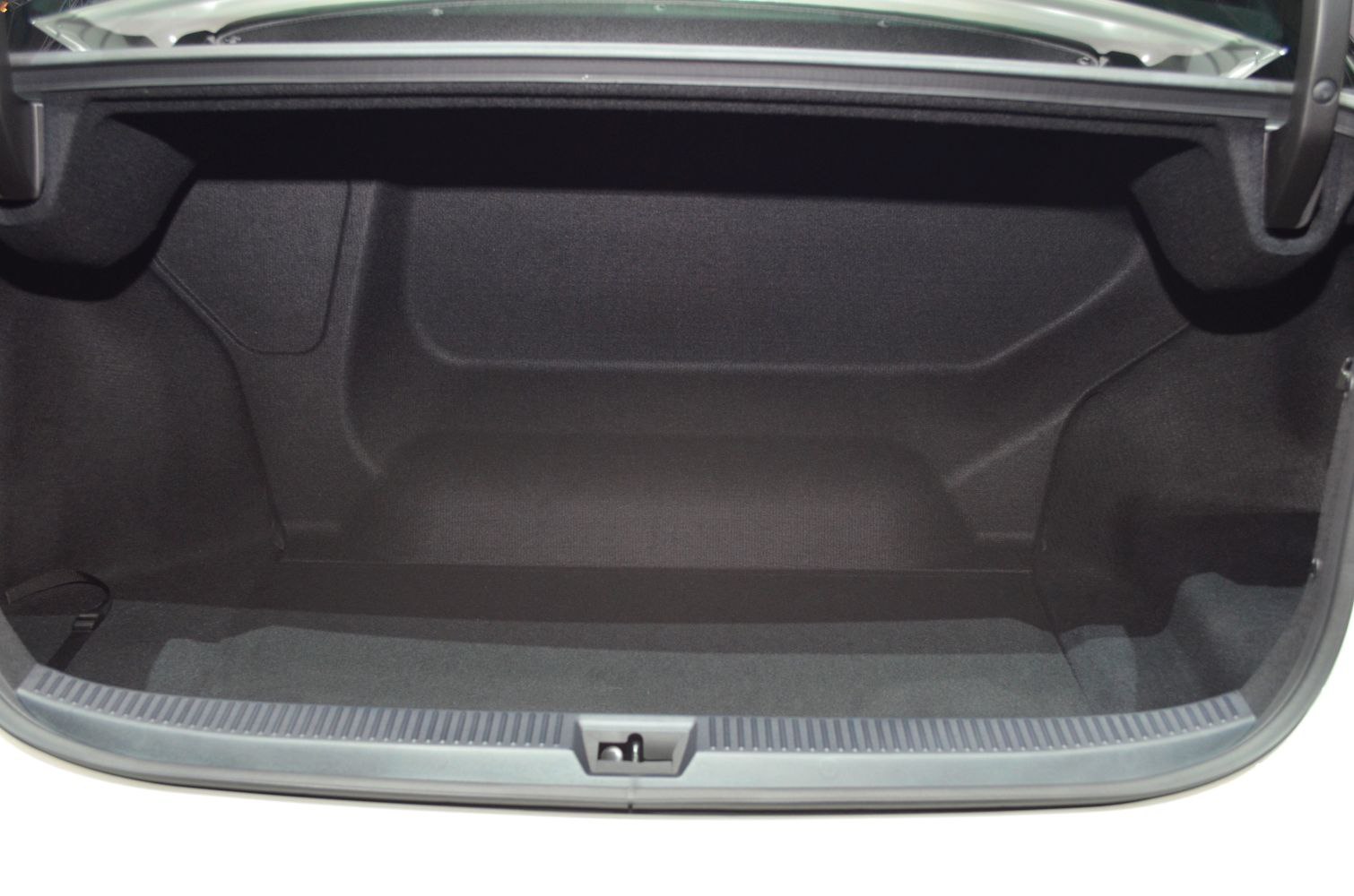 Empty spacious trunk interior with carpet lining and molded side walls