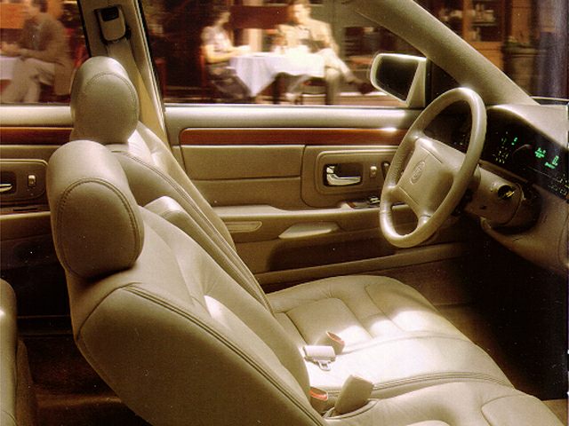 Beige leather front seats and classic dashboard interior