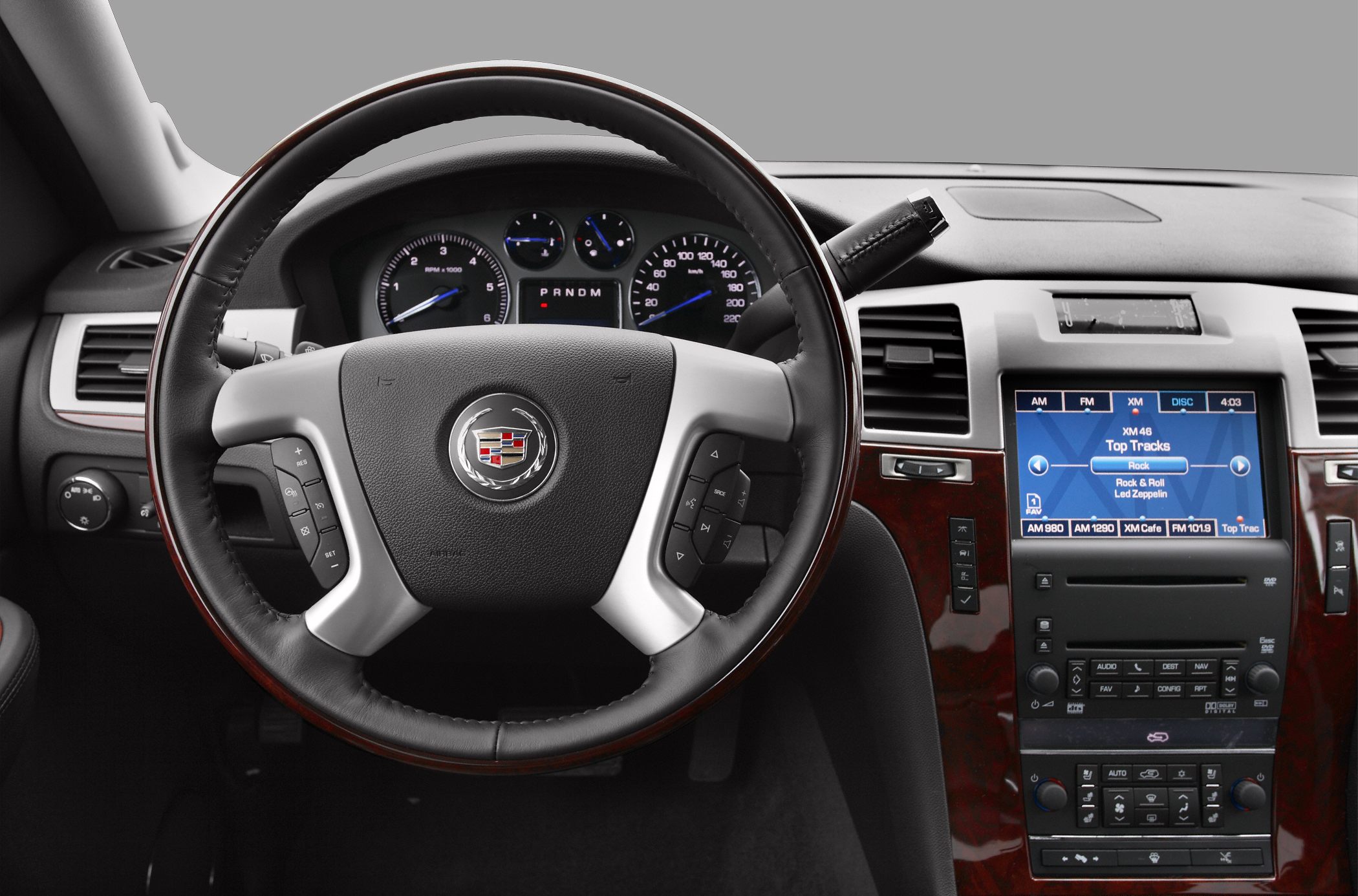 Steering wheel and dashboard with infotainment screen and control buttons