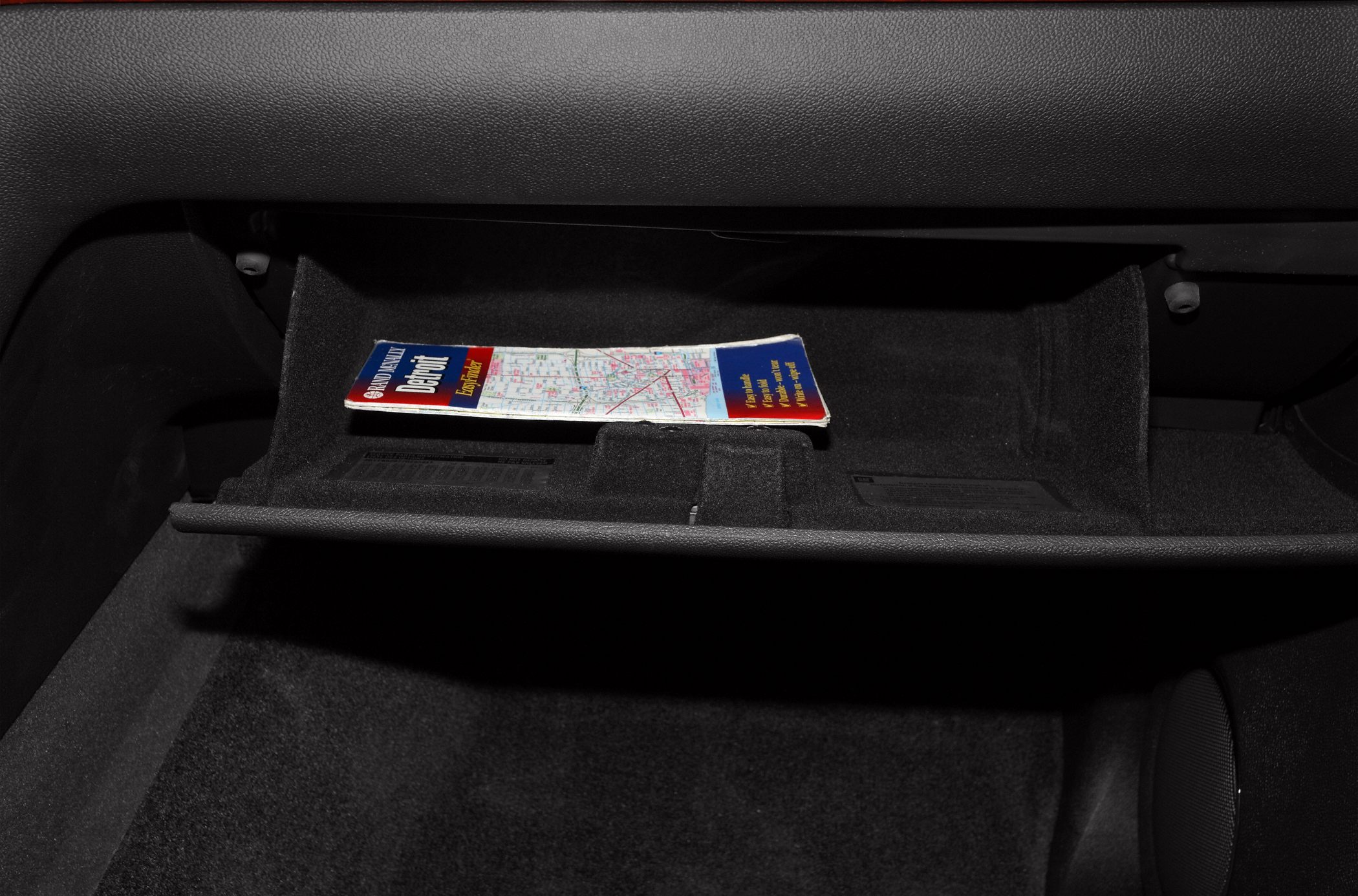 Open glove compartment with a folded map inside