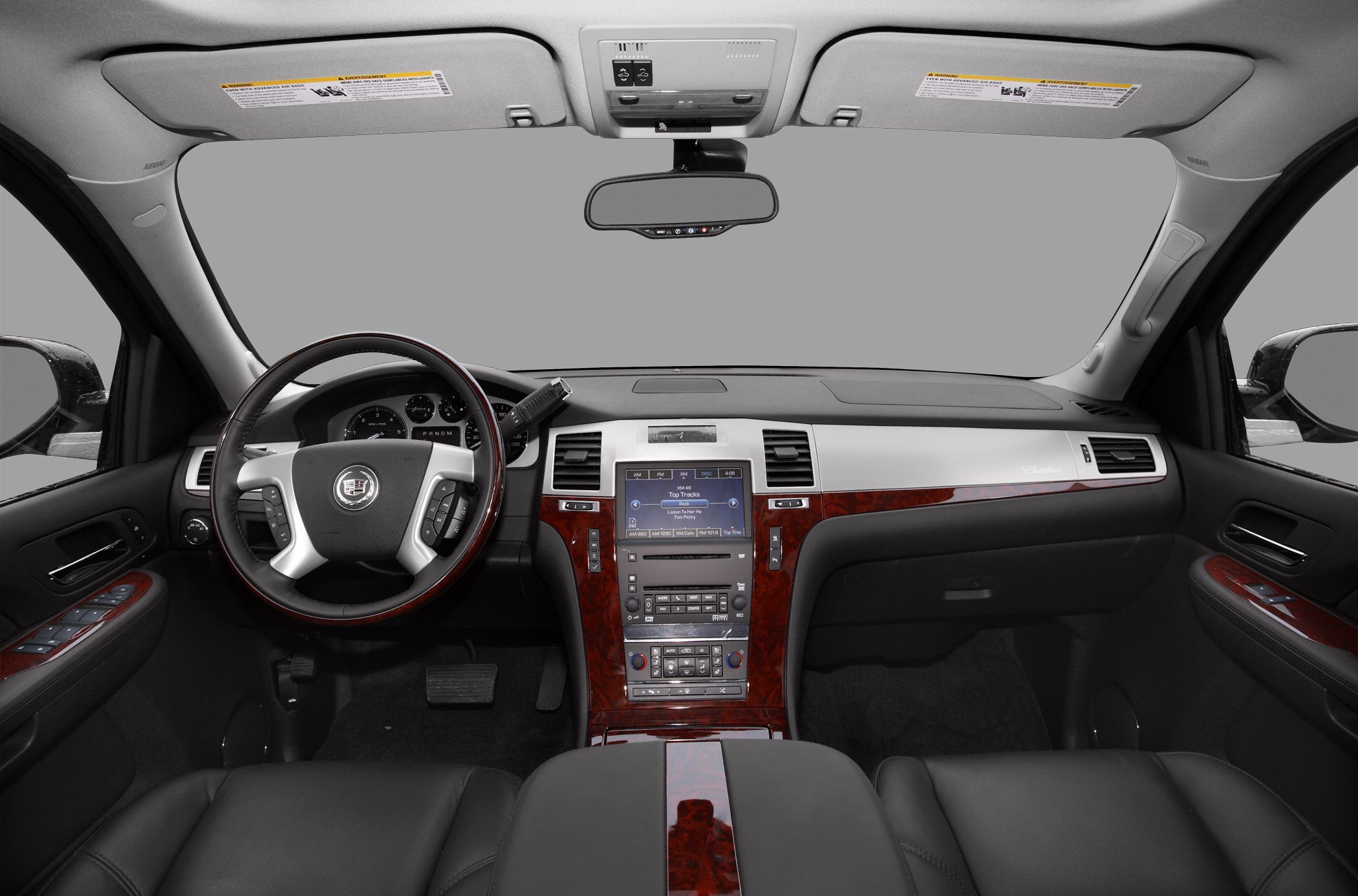 Dashboard and steering wheel with wood trim and multimedia controls
