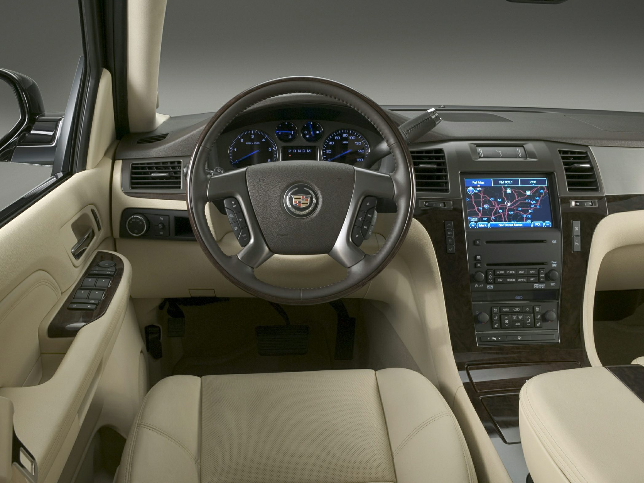 Beige leather interior with steering wheel and digital navigation system