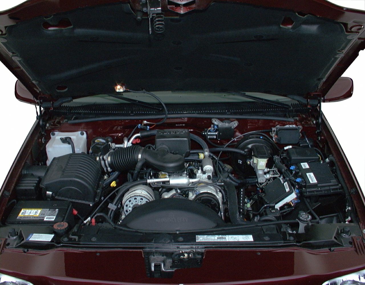 Open engine bay showing the detailed layout of an SUV powertrain.