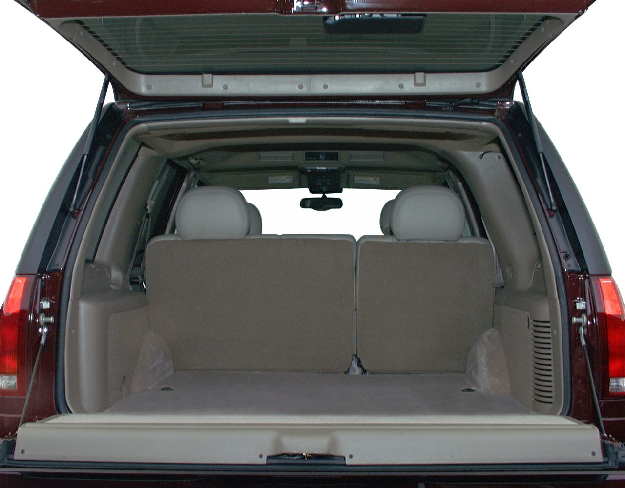 Open rear cargo area and tailgate of SUV with rear seats visible