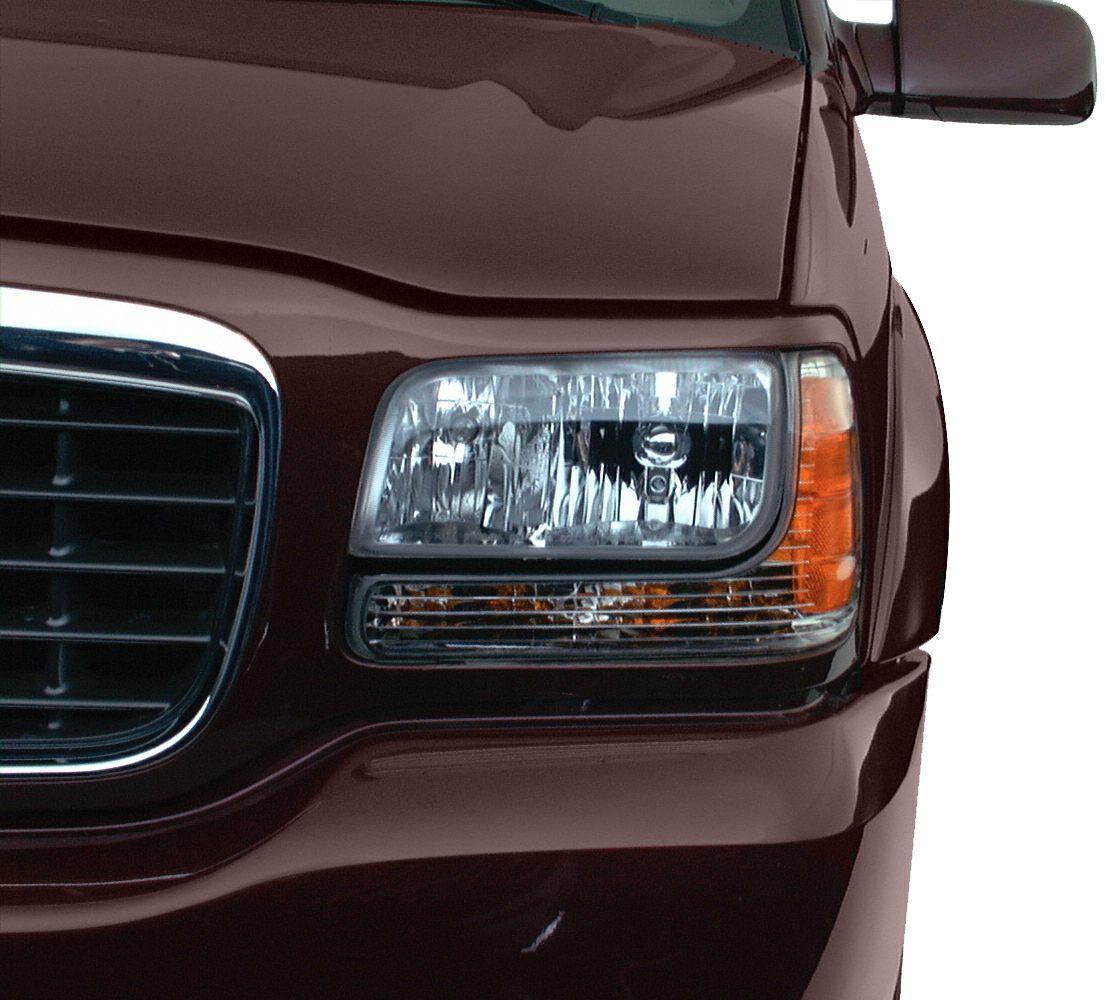 Close-up of headlight and front grill with side mirror