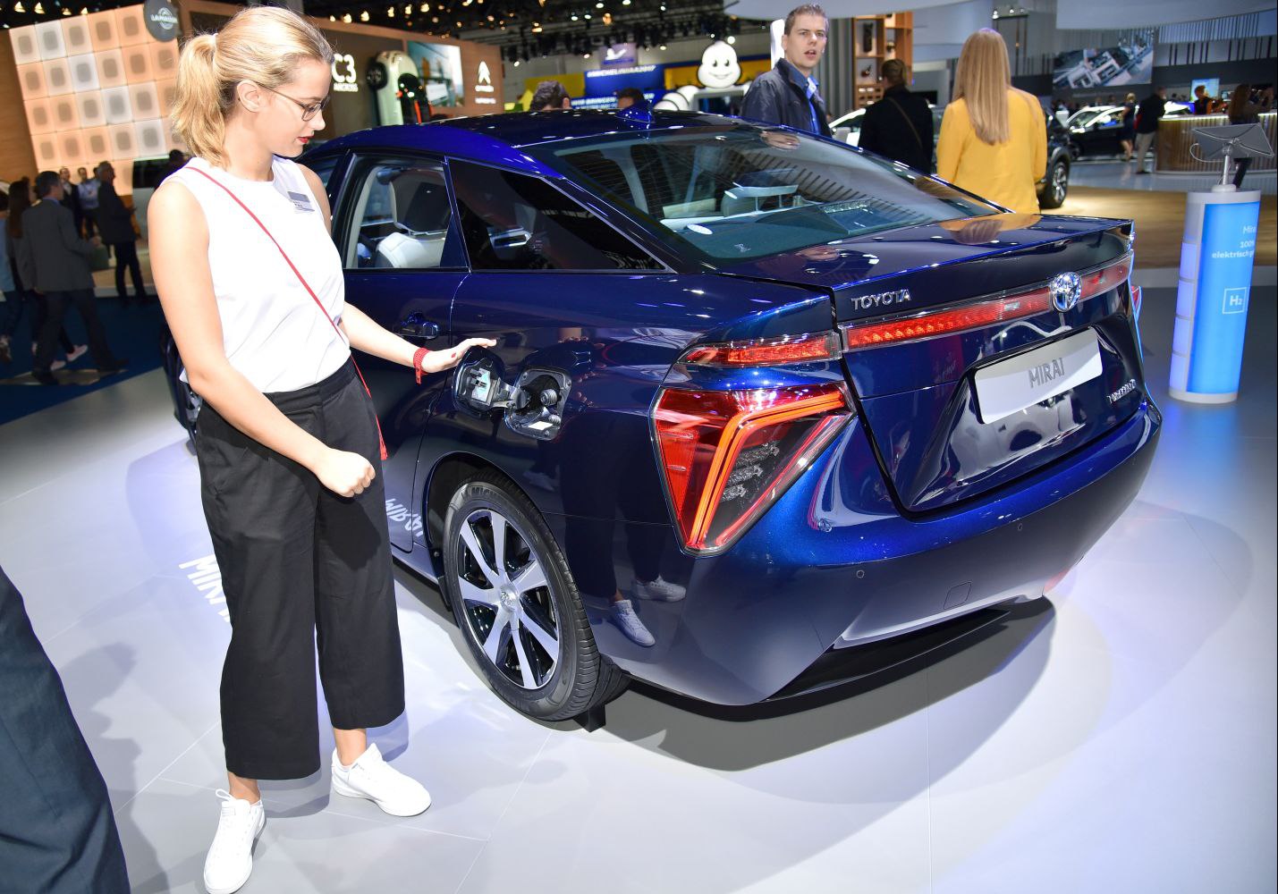 Rear and hydrogen fueling port of a blue sedan with distinctive tail lights