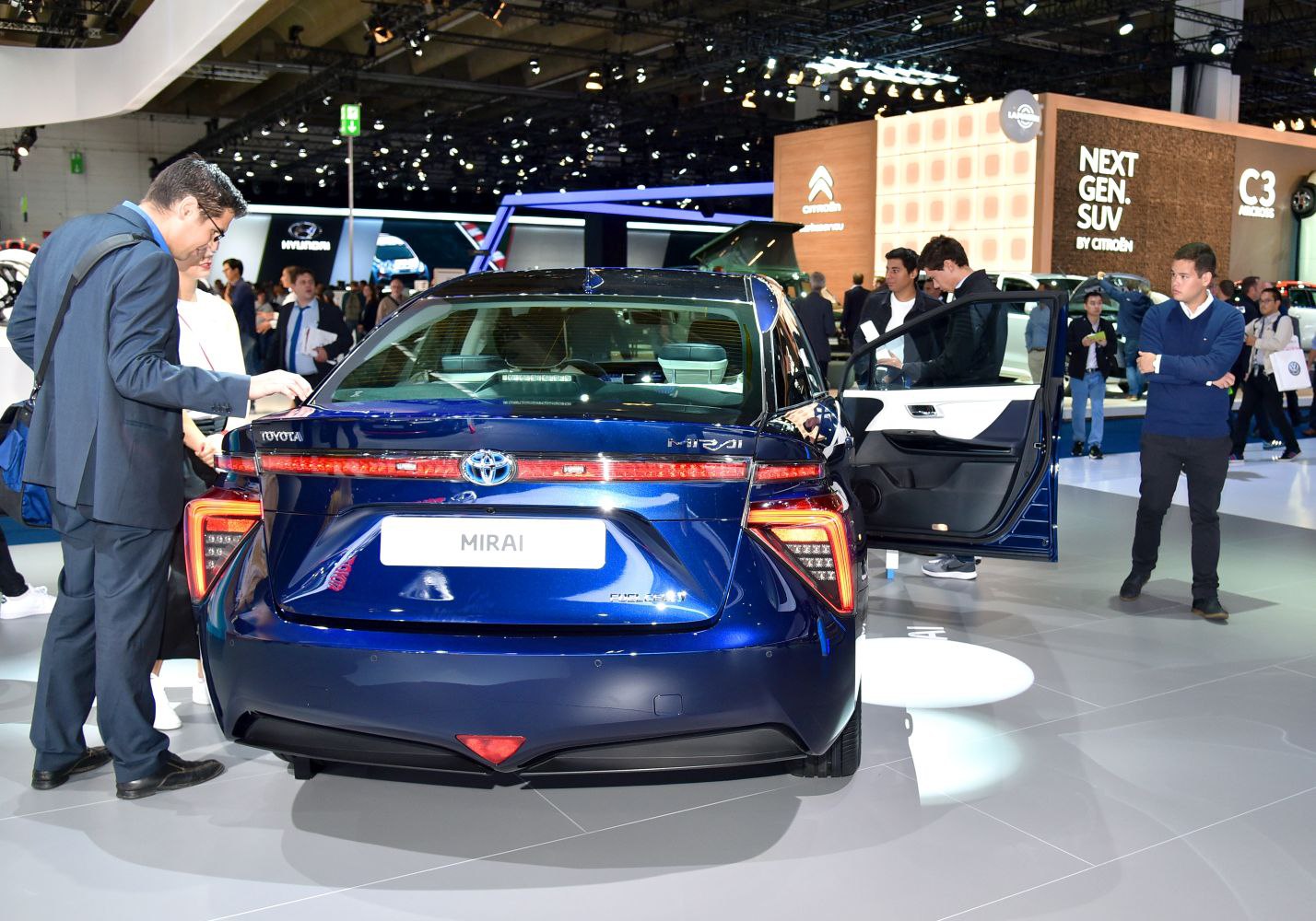 Rear view with distinctive futuristic taillights and open door