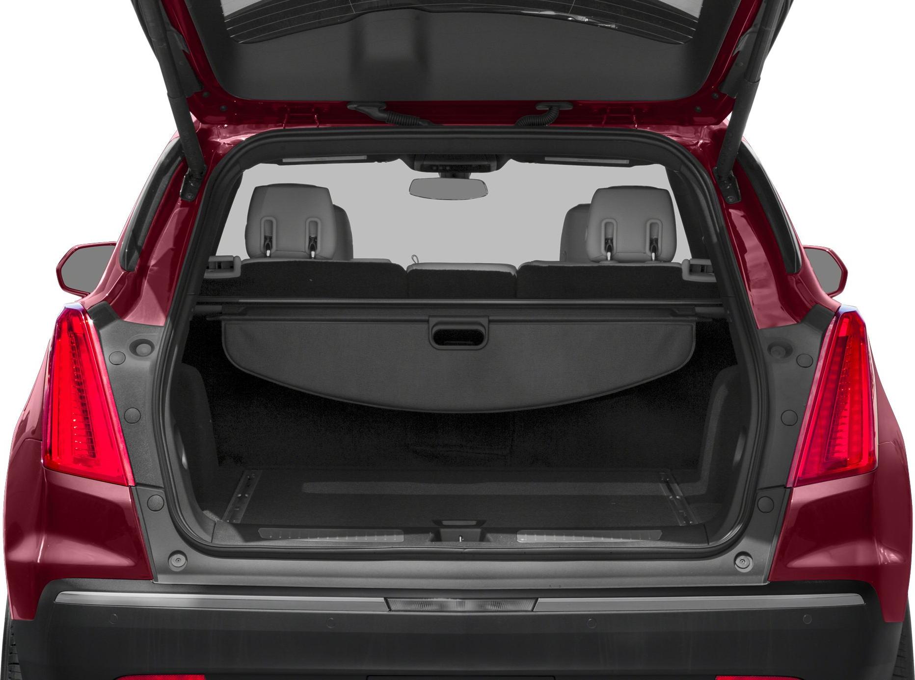 Rear trunk space with retractable cargo cover and headrests