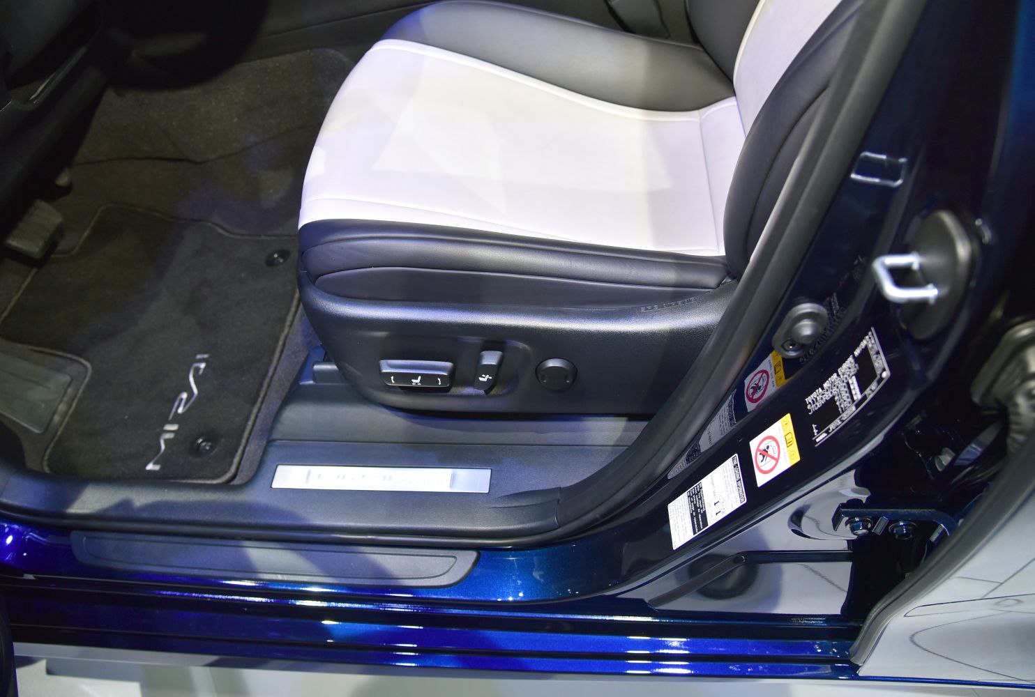 Electric front seat adjustment controls and branded floor mat