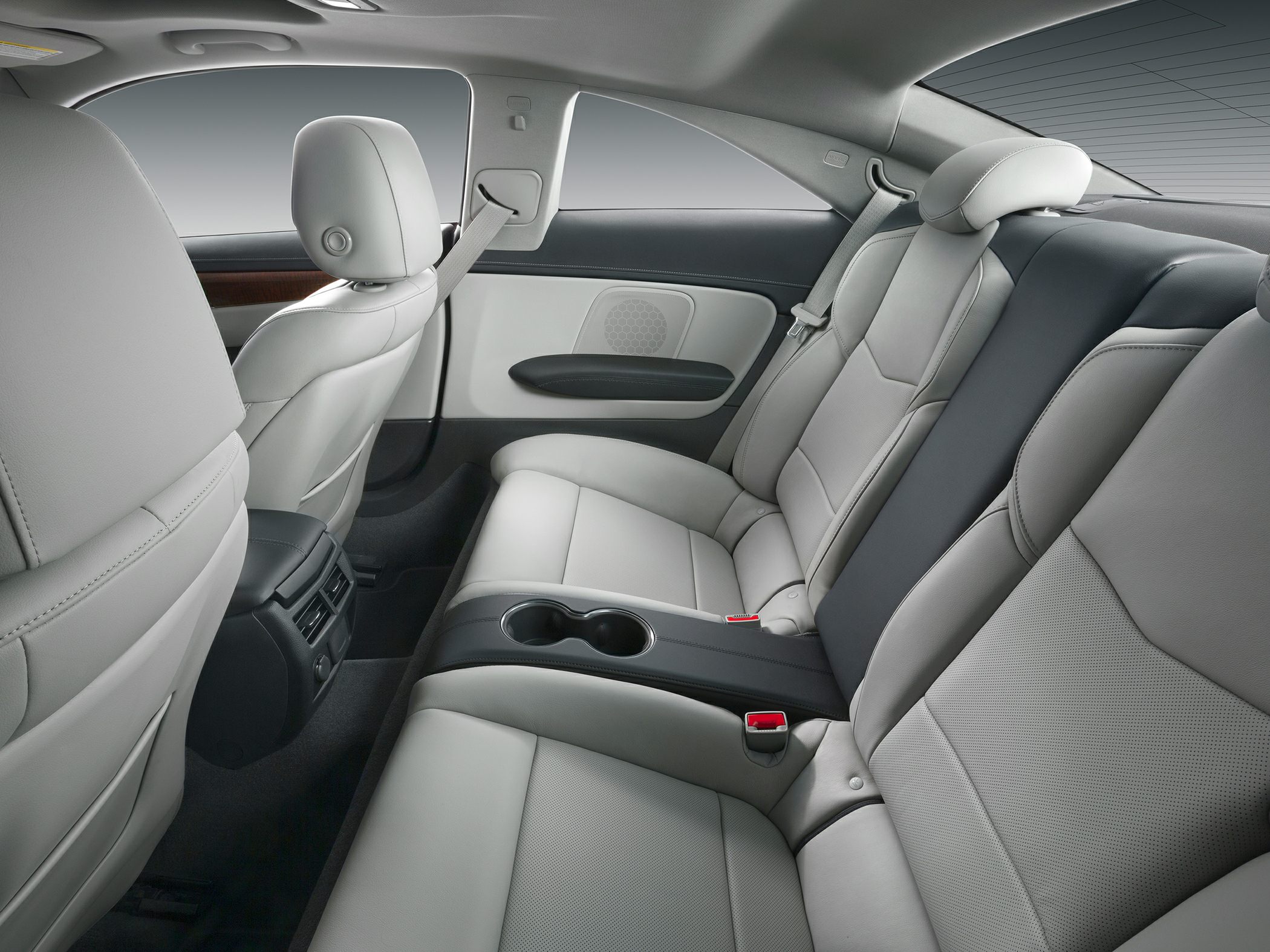 Luxurious rear seats with leather upholstery and central armrest cup holders.