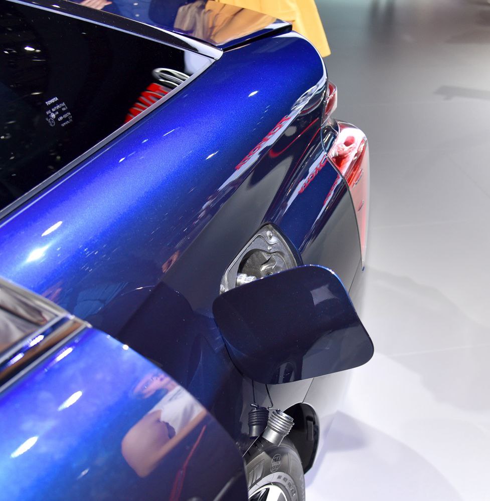 Close-up of blue car's fuel filler port and rear light detail.