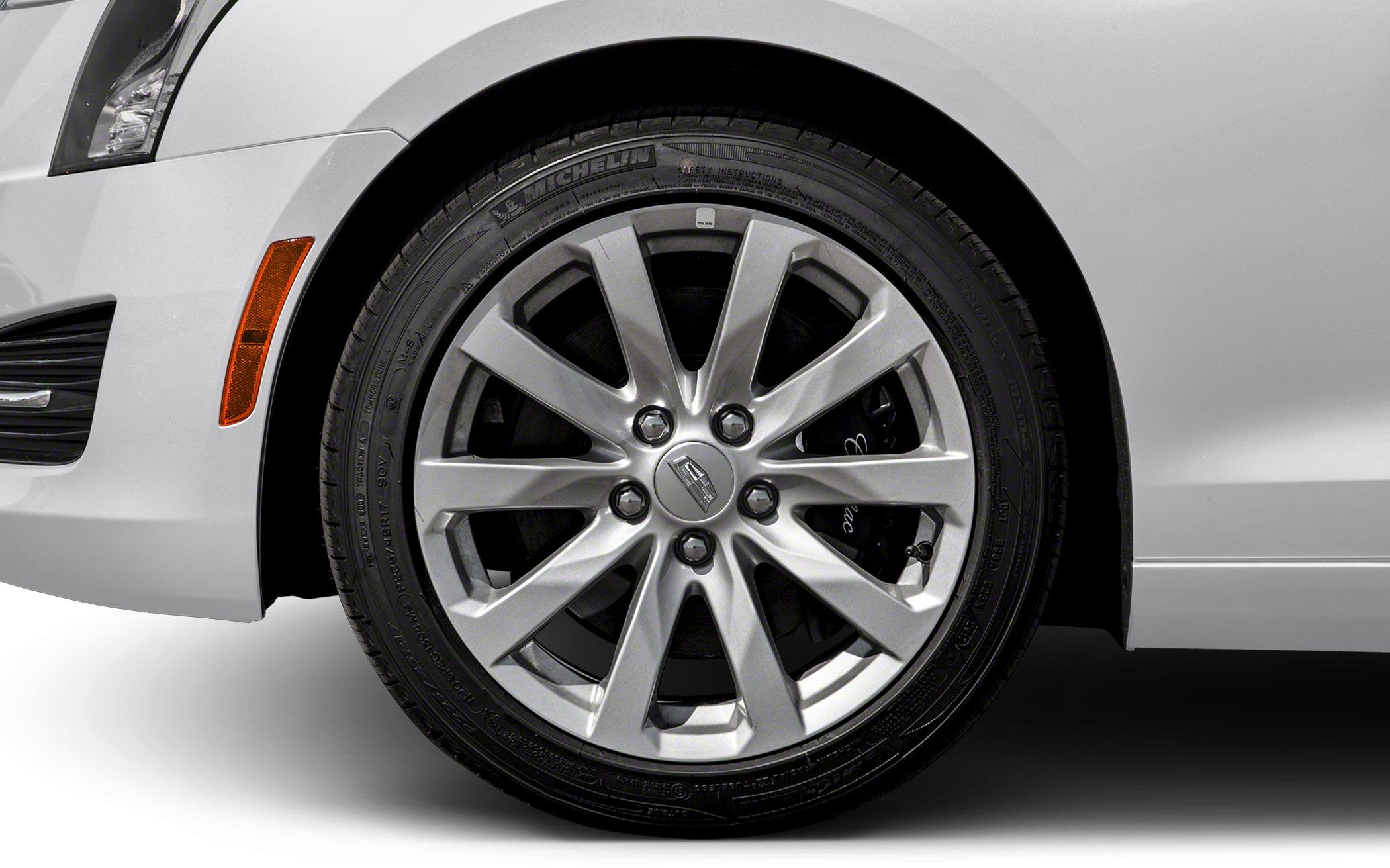Alloy wheel and side marker reflector of a car.
