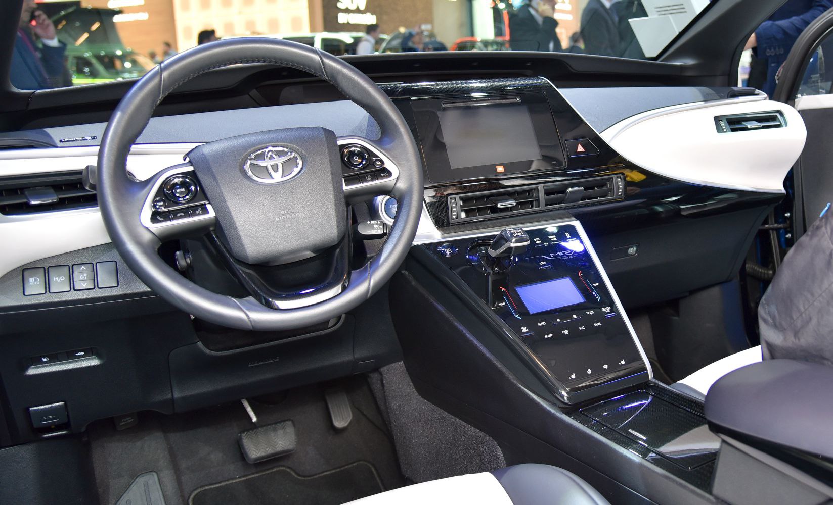 Digital dashboard, steering wheel with controls, and modern center console.