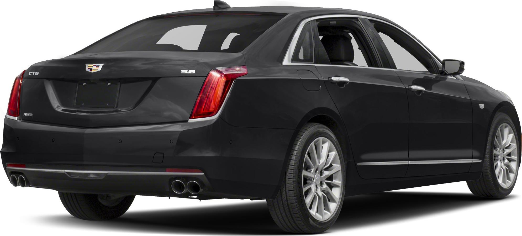 Black sedan rear quarter view with dual exhaust and alloy wheels