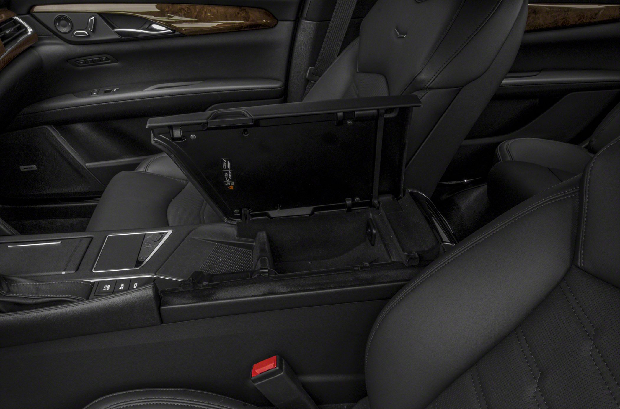Open center console storage and front leather seats in luxury car interior