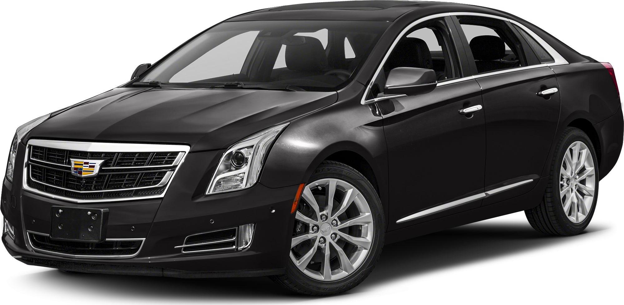 Front grille and alloy wheels of a black sedan