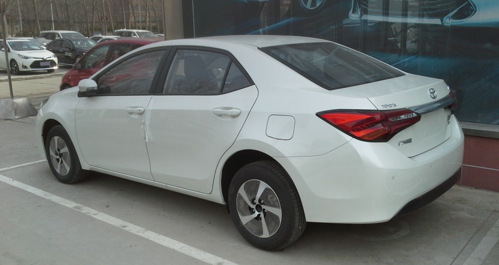 Rear and side view of a white modern sedan with distinct tail lights and door design