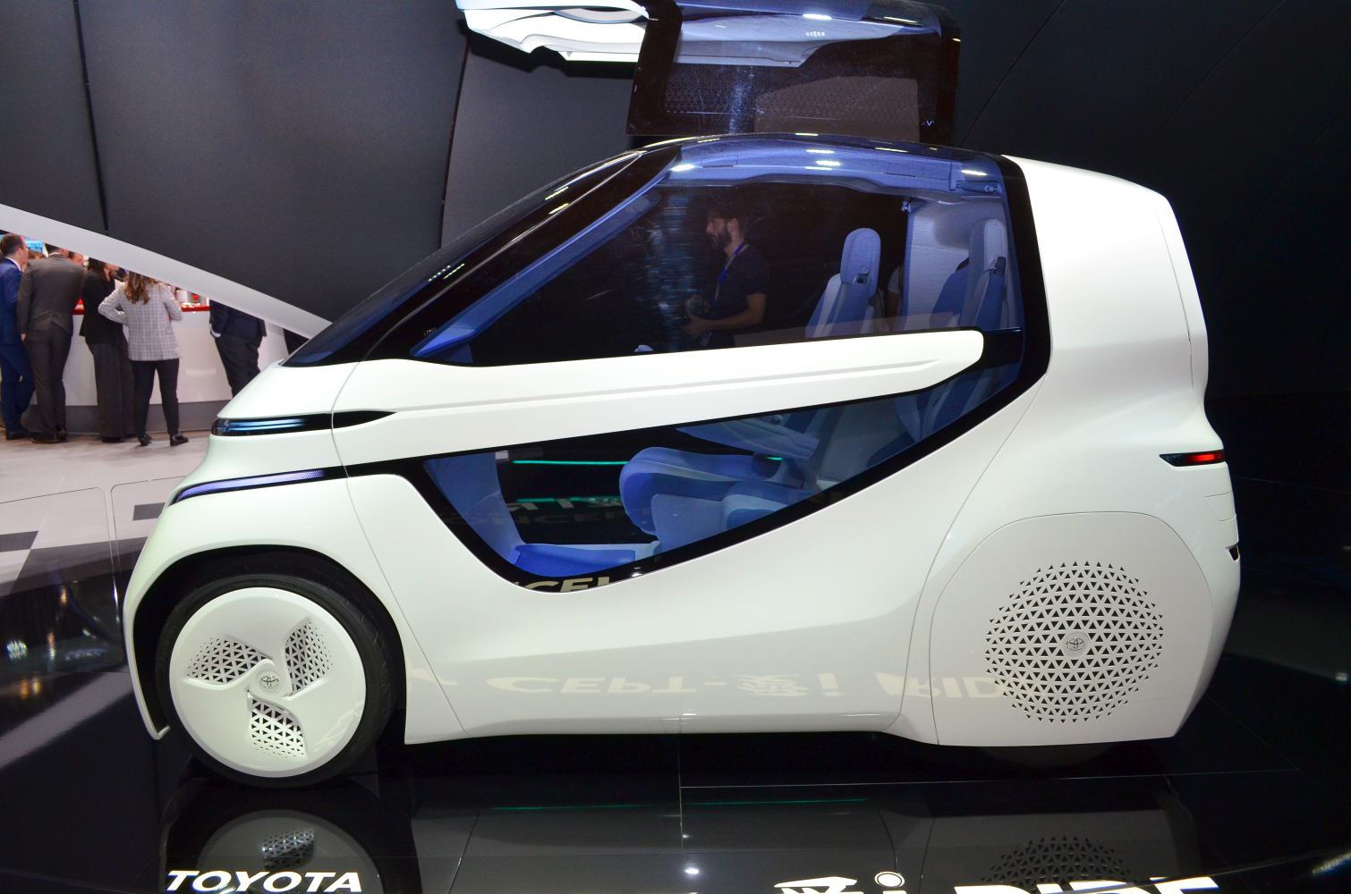 Futuristic compact urban vehicle with transparent cabin and innovative design.
