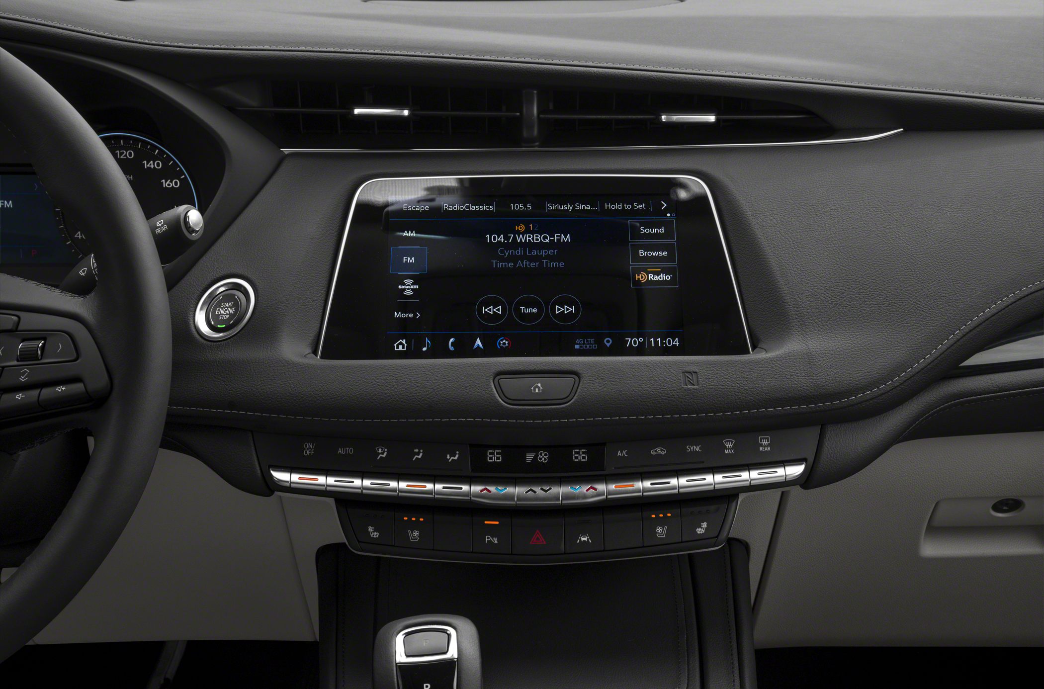 Touchscreen infotainment and climate control panel with digital gauges and ergonomic buttons