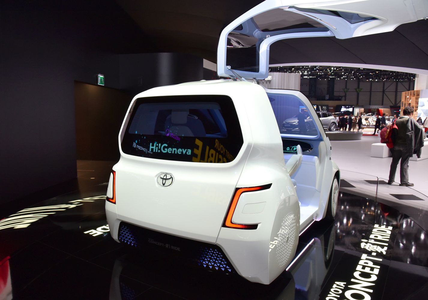 Rear view of futuristic compact electric vehicle with gullwing door