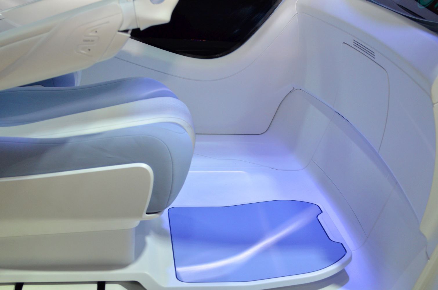 Futuristic seat with ambient blue floor lighting in modern interior