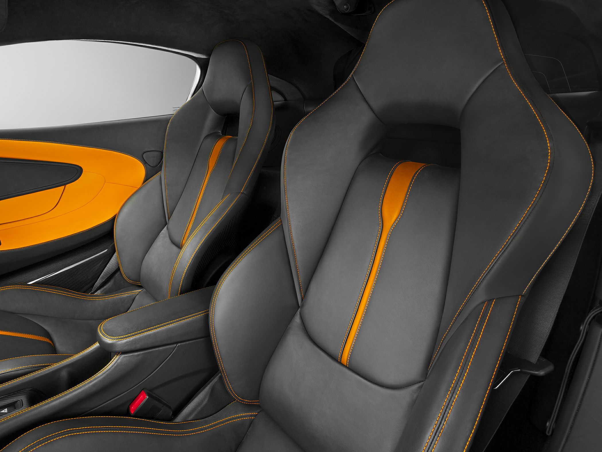 Black interior seats with orange accents and detailed stitching.