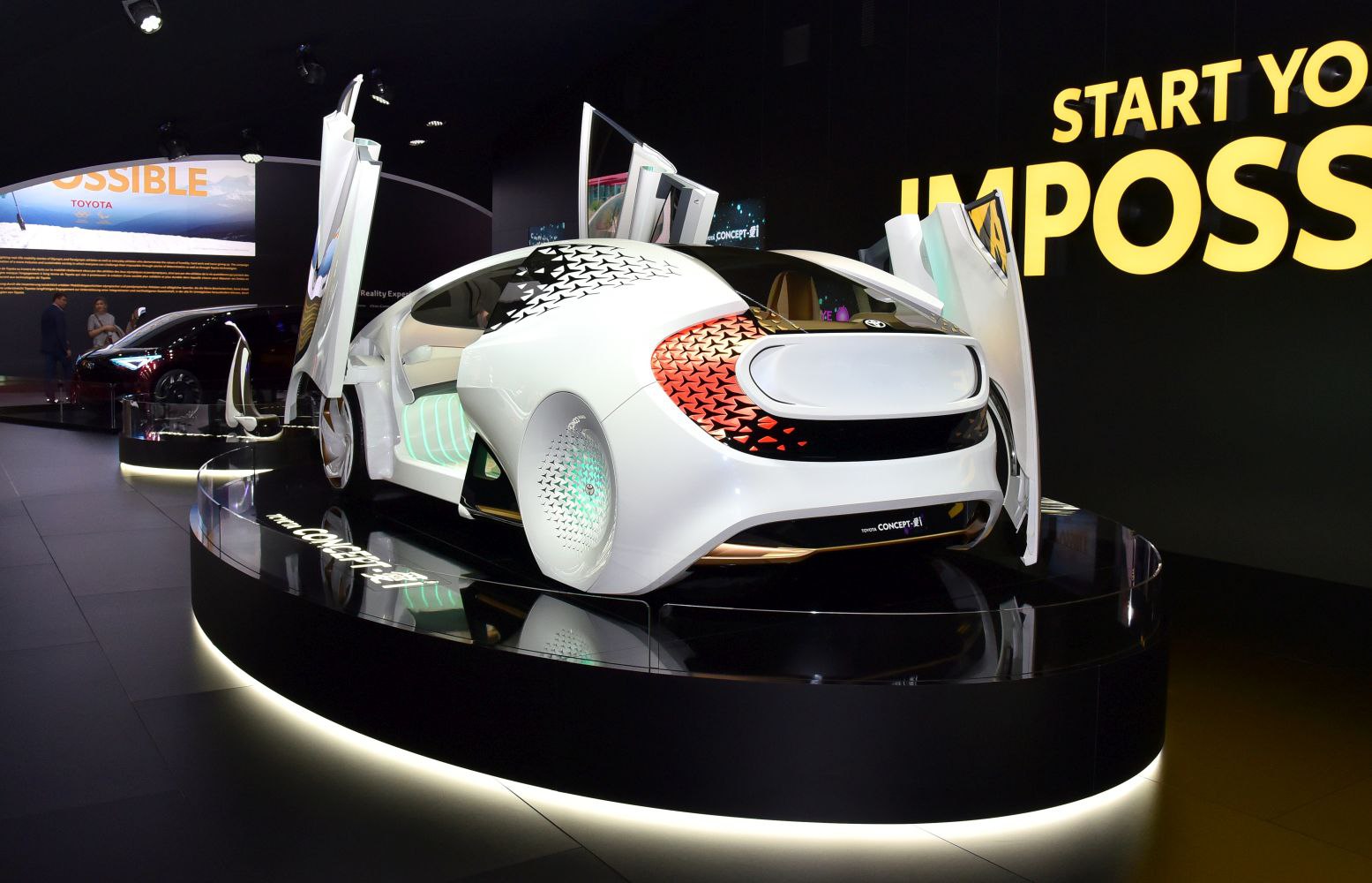 Futuristic white concept car with gullwing doors and illuminated wheels