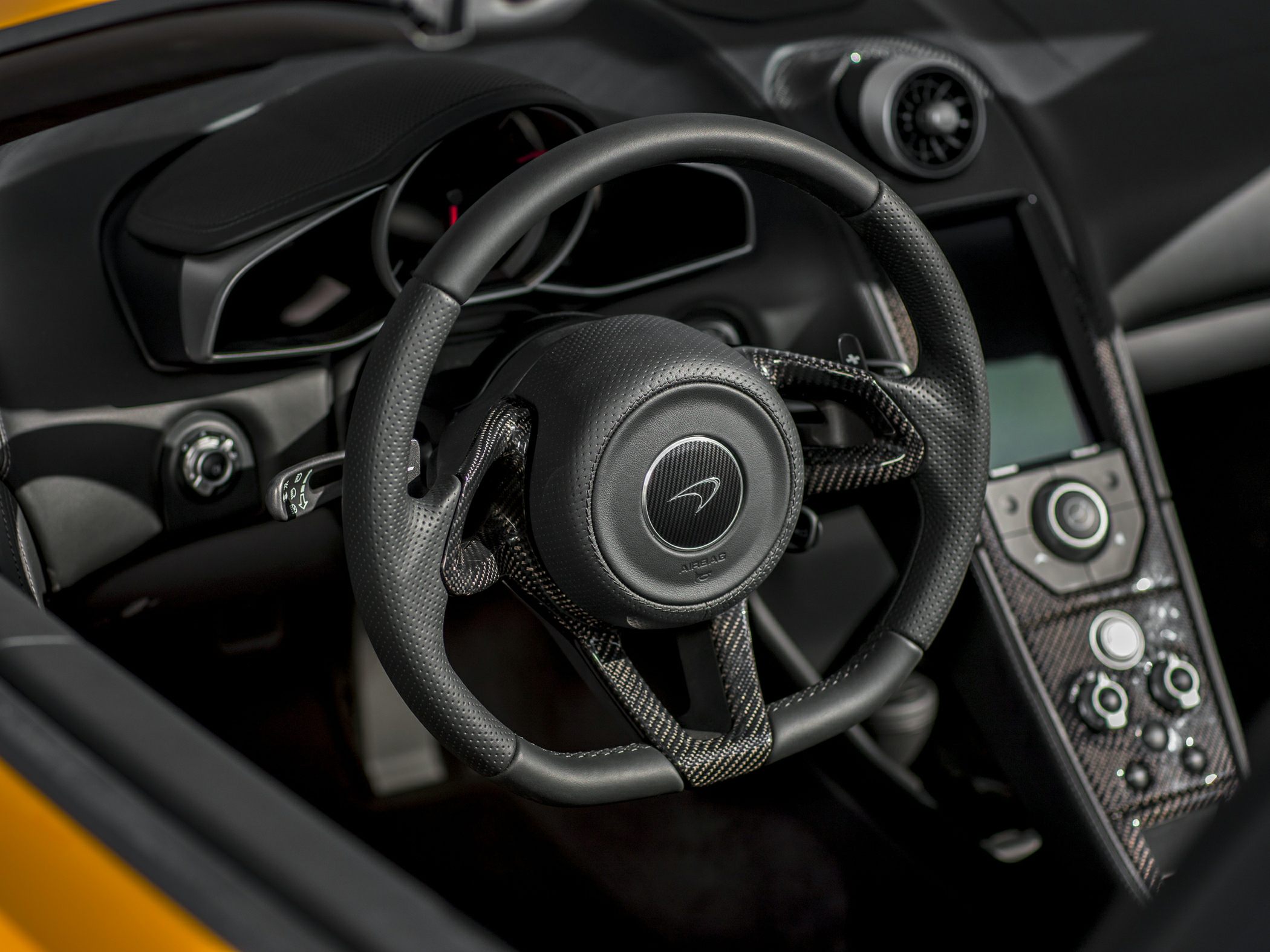 Carbon fiber steering wheel and center console controls