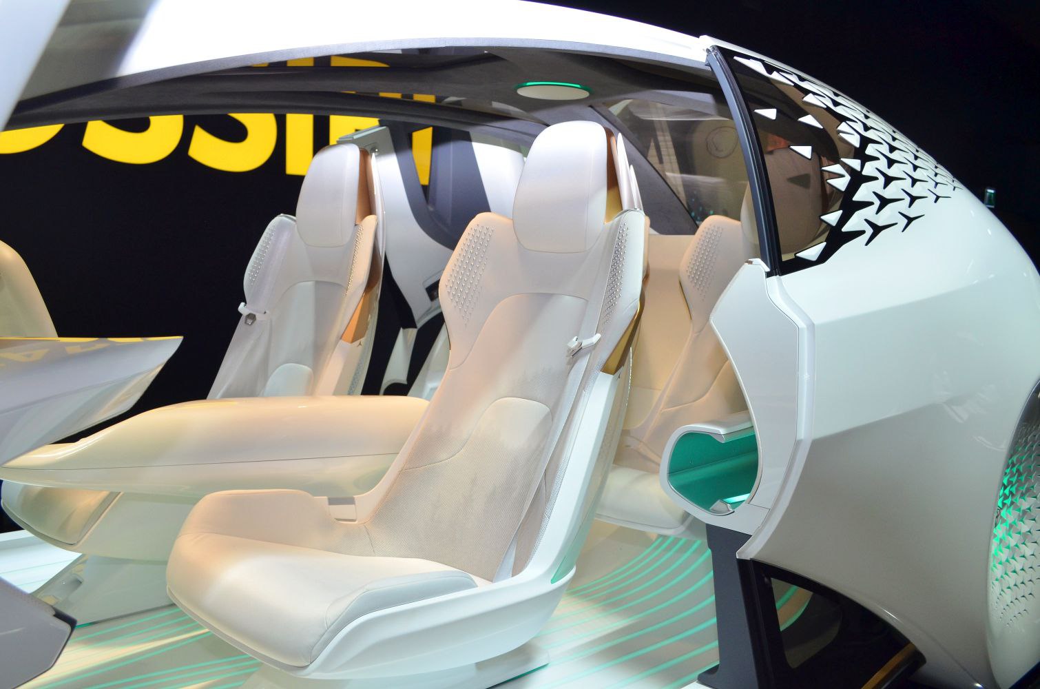 Futuristic white advanced vehicle seats and innovative door design.