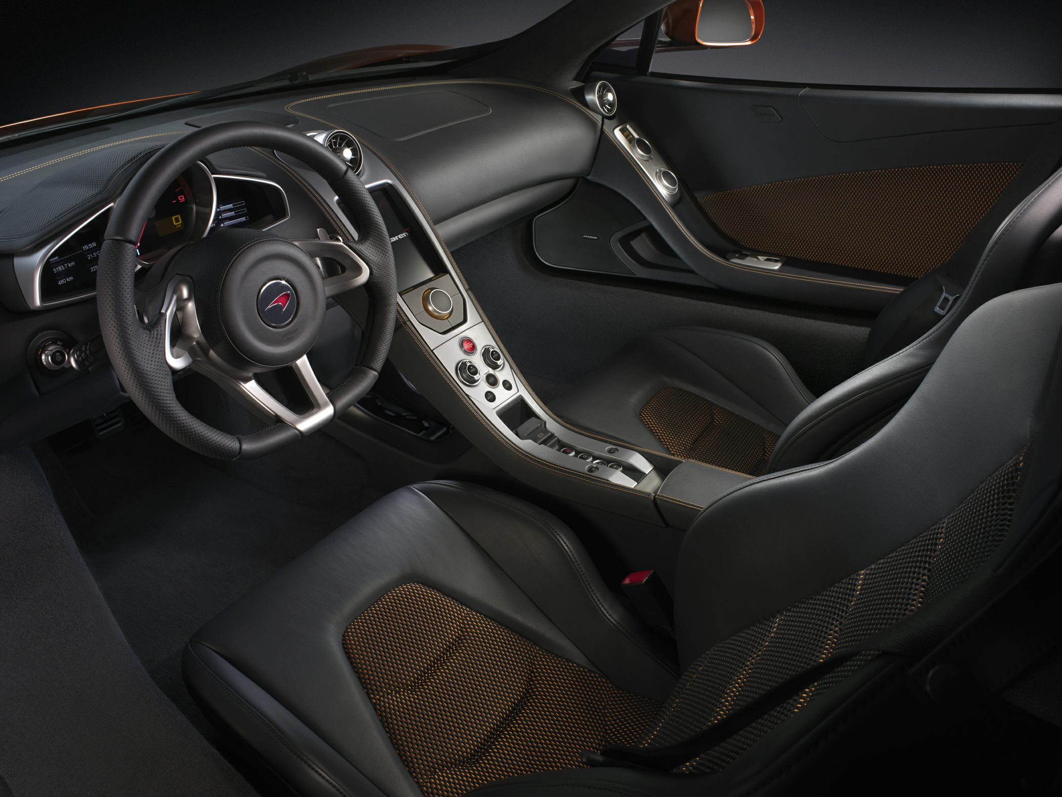 Luxury car interior with dashboard, steering wheel, and sporty seats