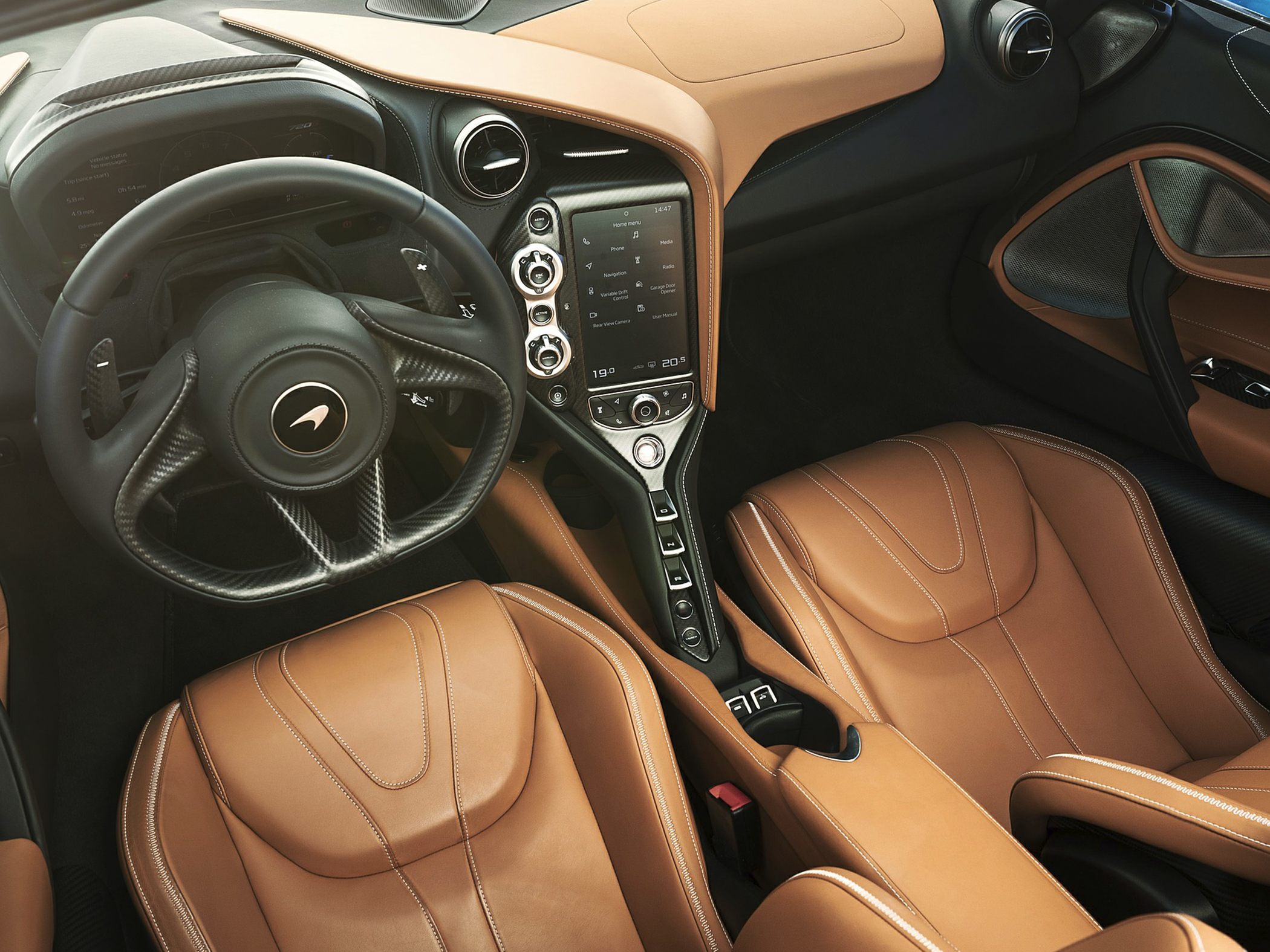 Tan leather seats with carbon fiber steering wheel and digital controls