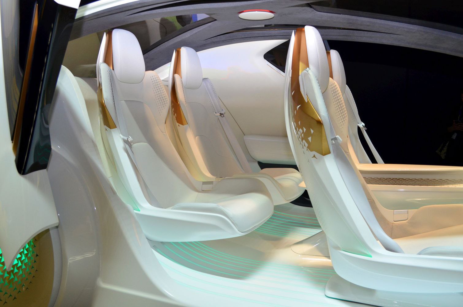 Futuristic white seats with gold backrests in a sleek concept car interior